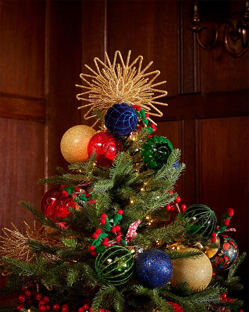 A gift bag with a Christmas design, decorated with a star, lametta