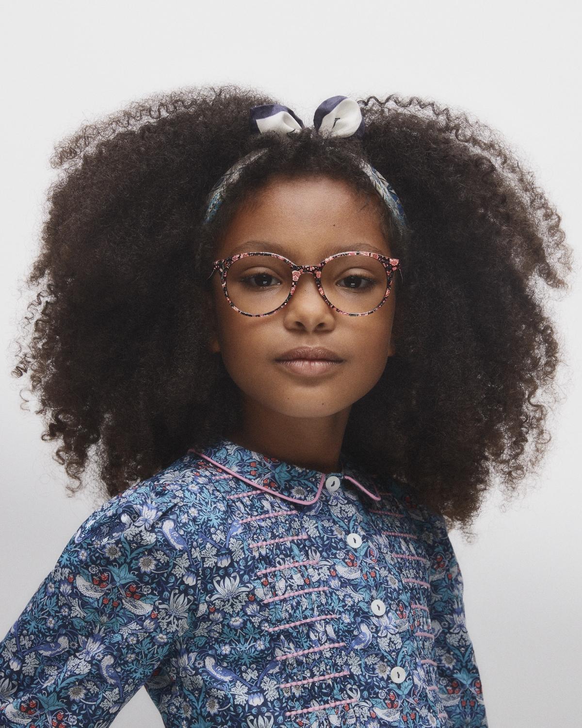 Girl wearing Liberty dress and glasses