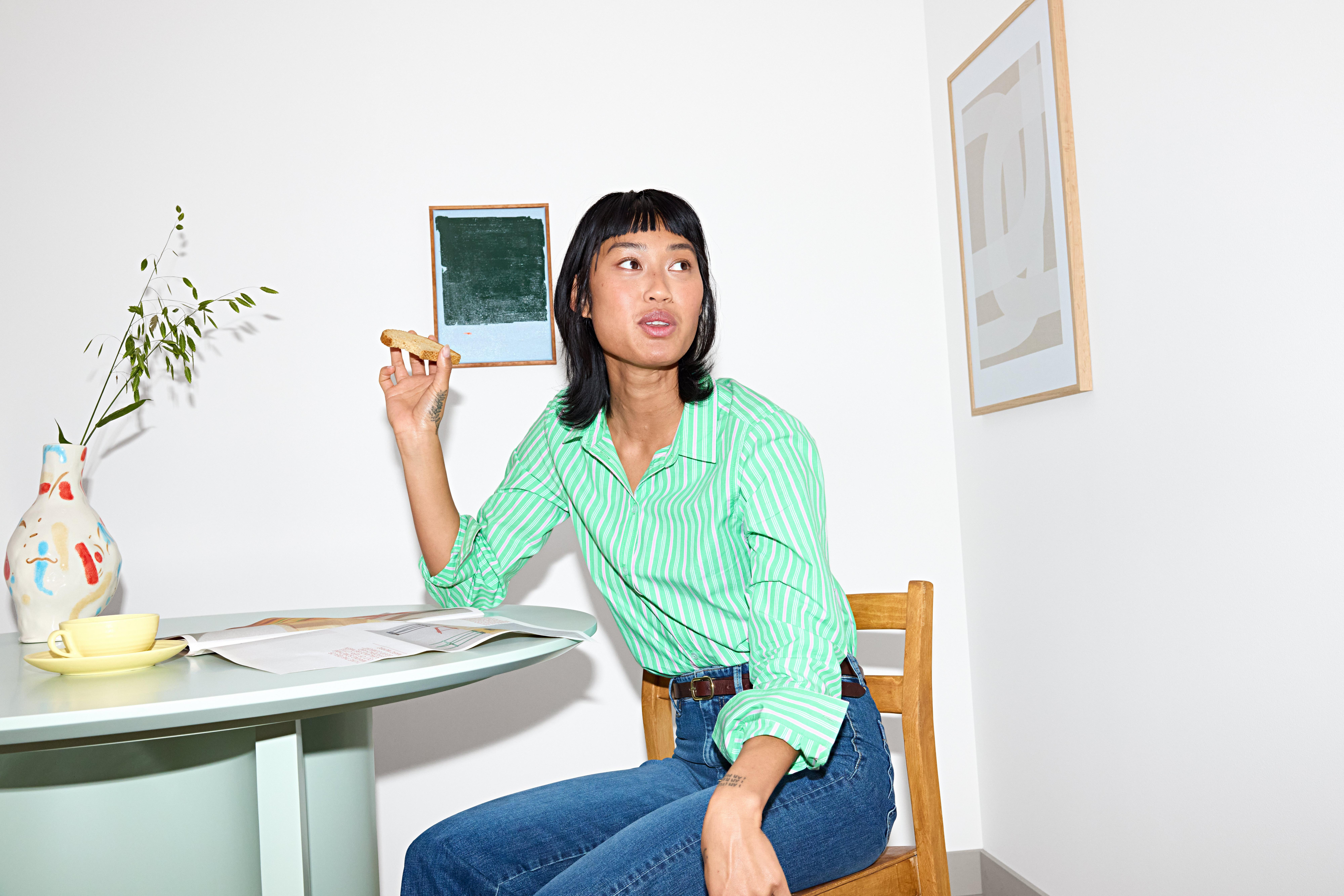 Woman in jeans and green blouse