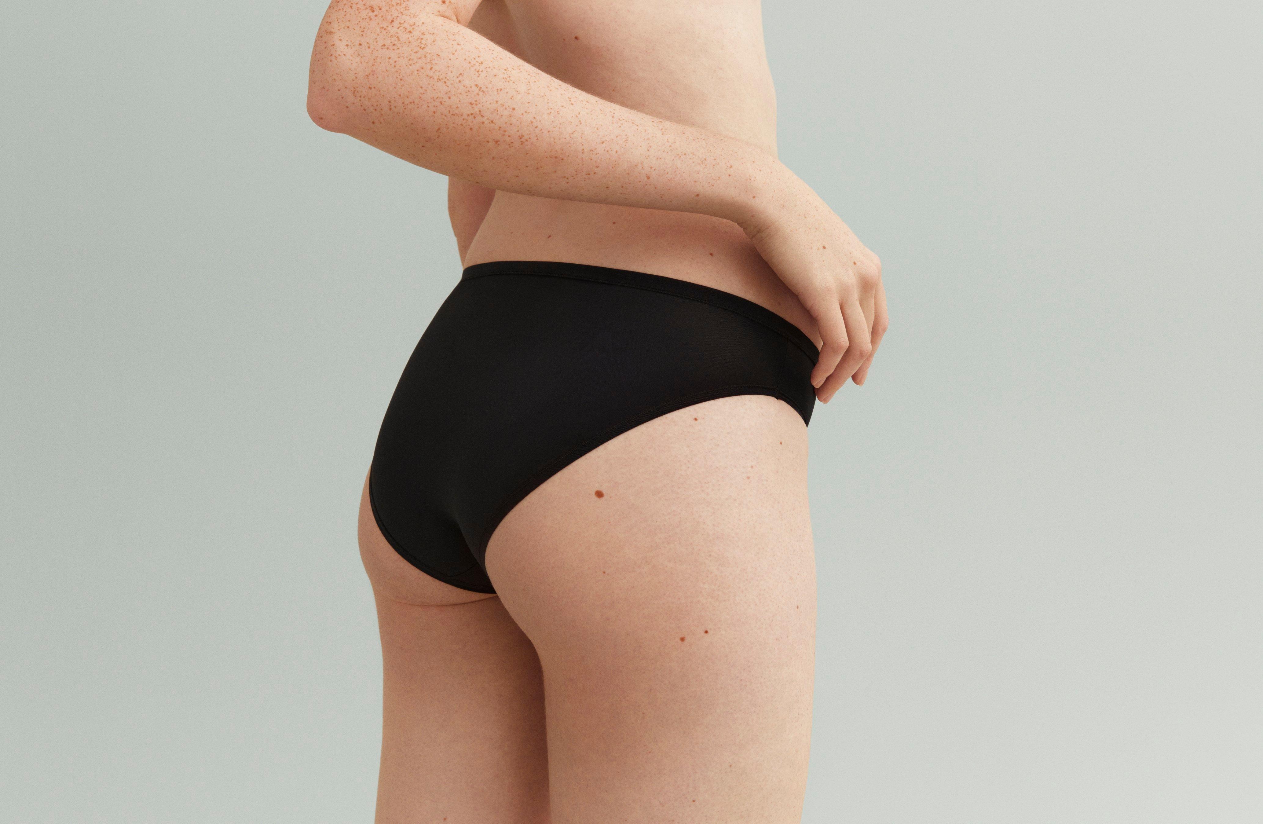 A woman in black bikini knickers.