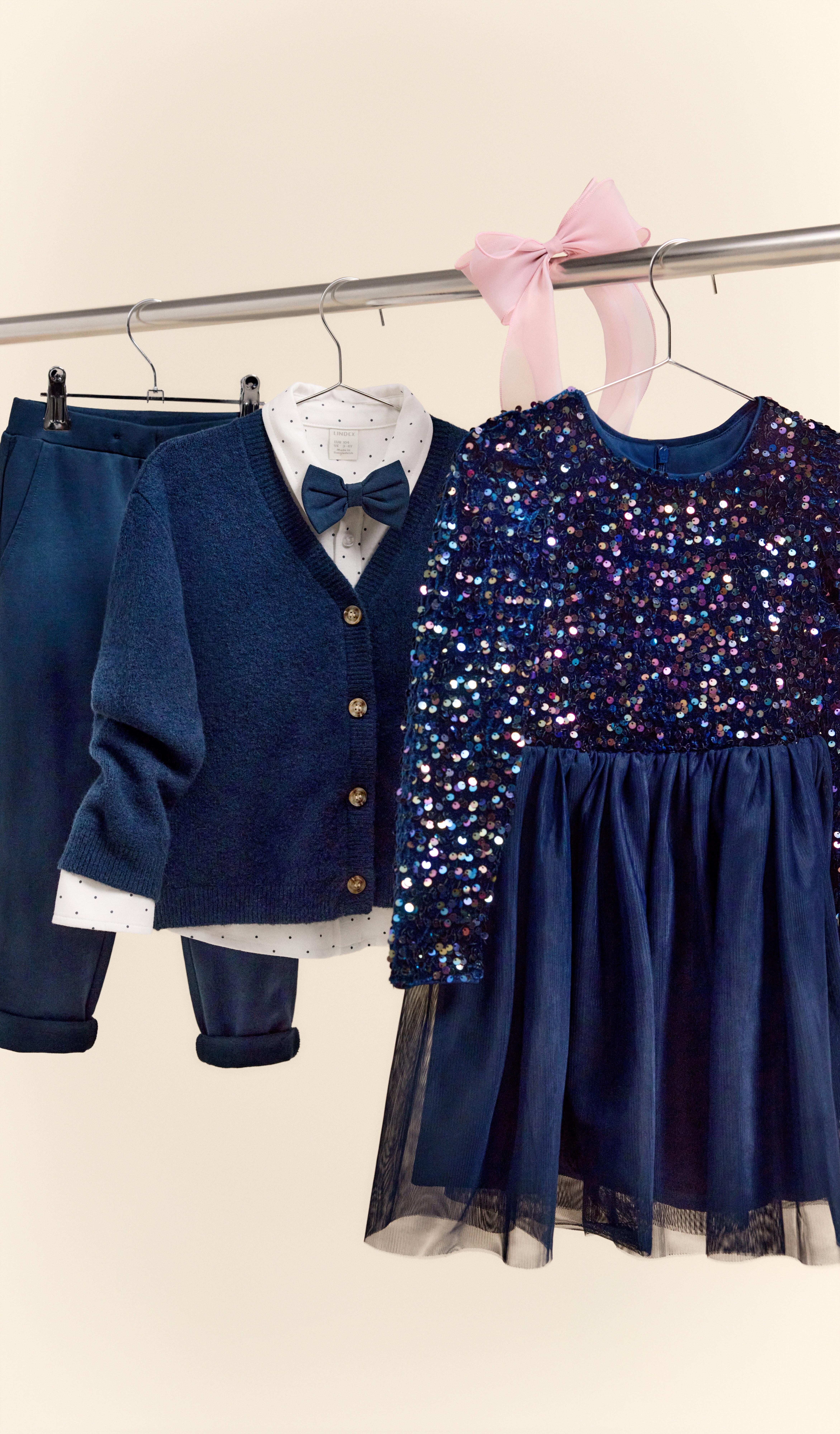 Flera blåa festkläder hänger på en klädstång.