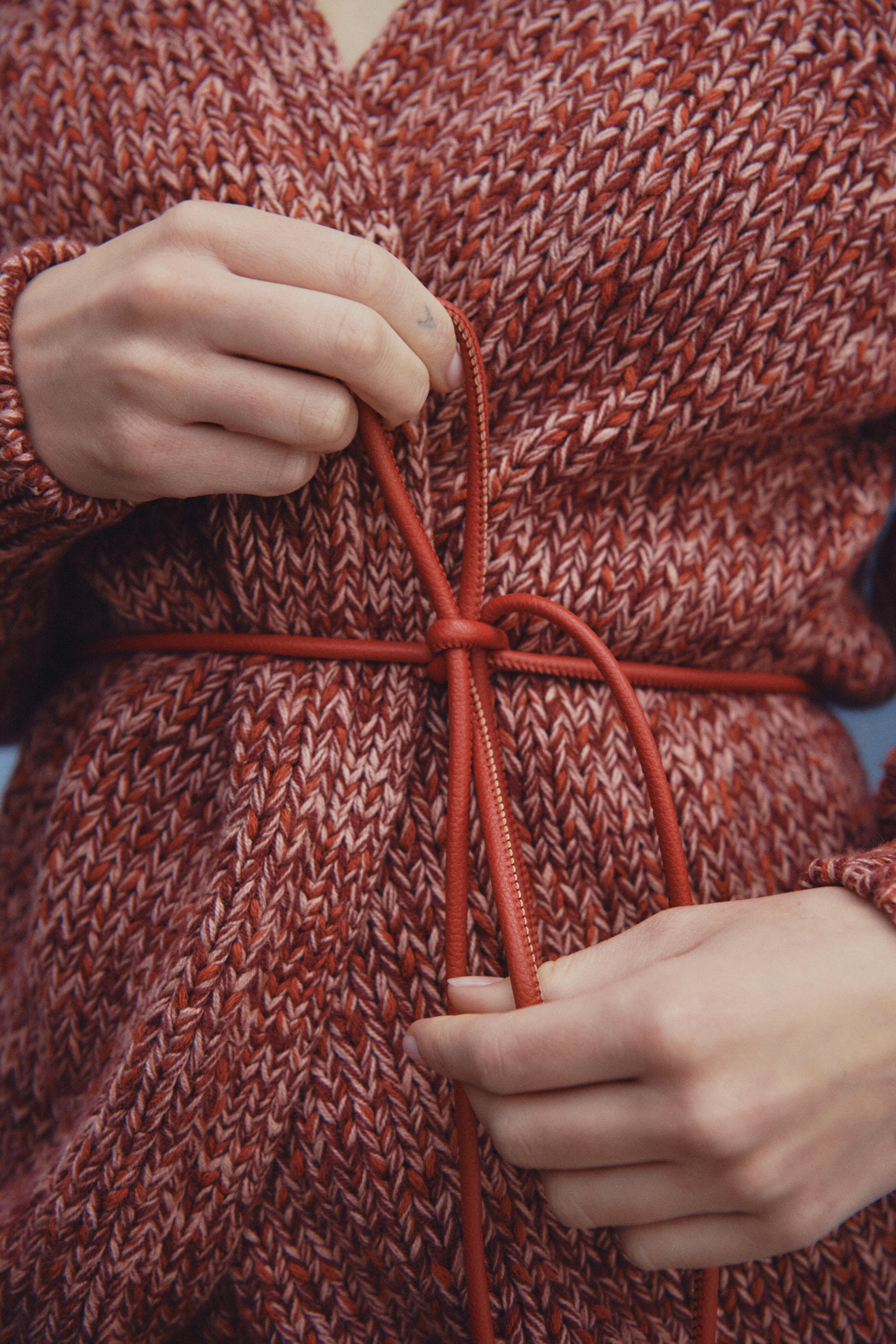 a close-up of a brown, knitted cardigan.