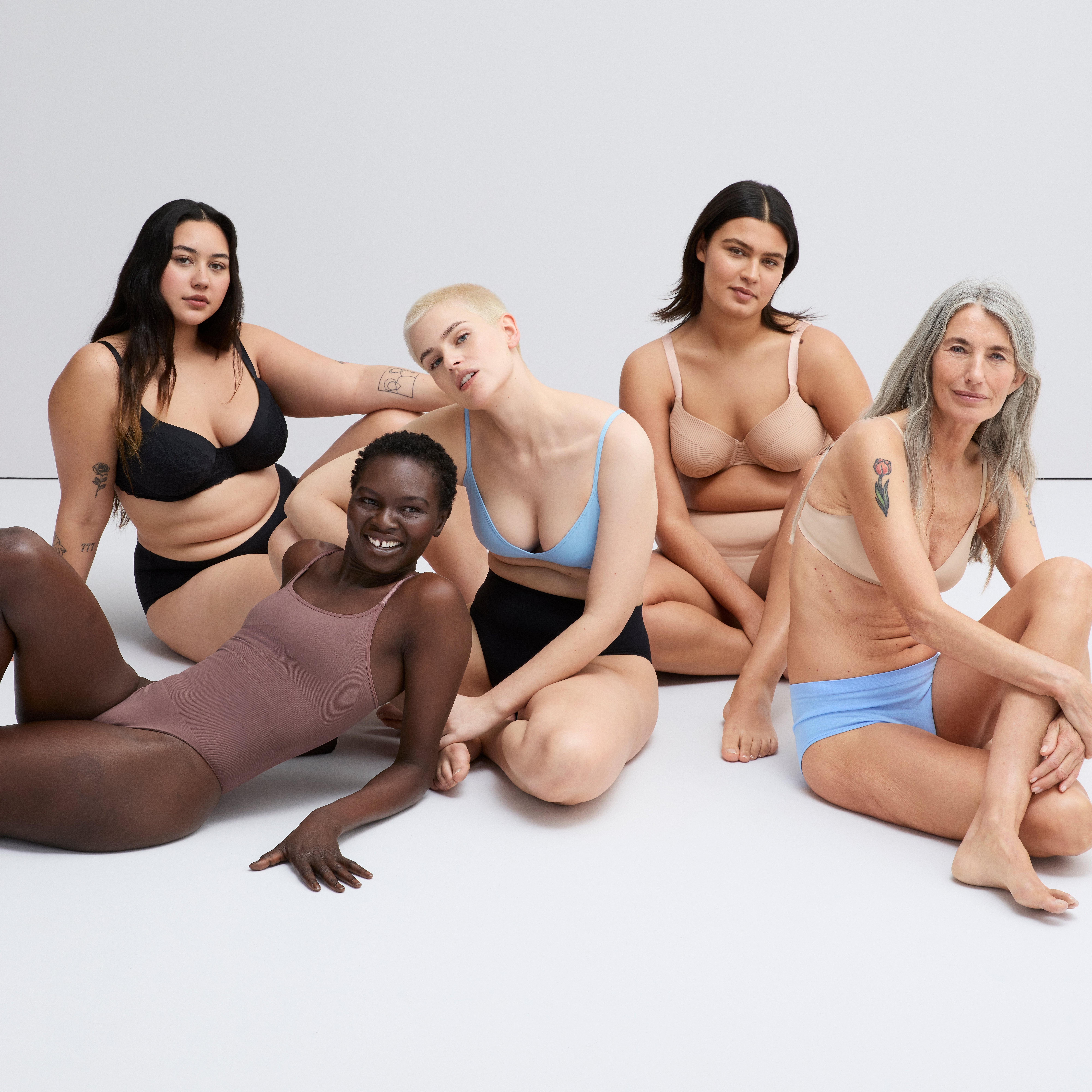 A group of women sitting on the floor wearing different types of underwear from Lindex.