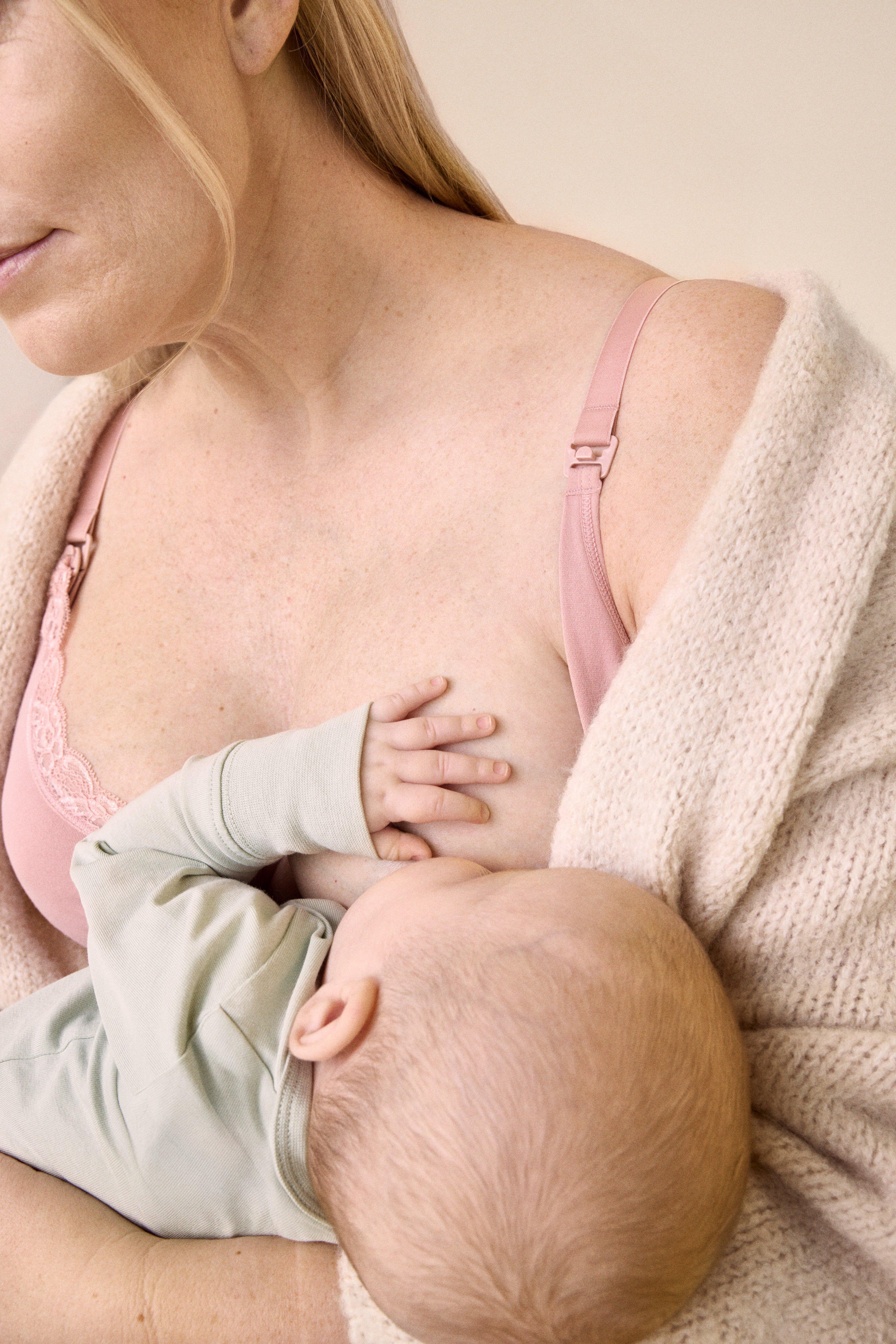 A baby breastfeeding in soft and comfortable clothes from Lindex.