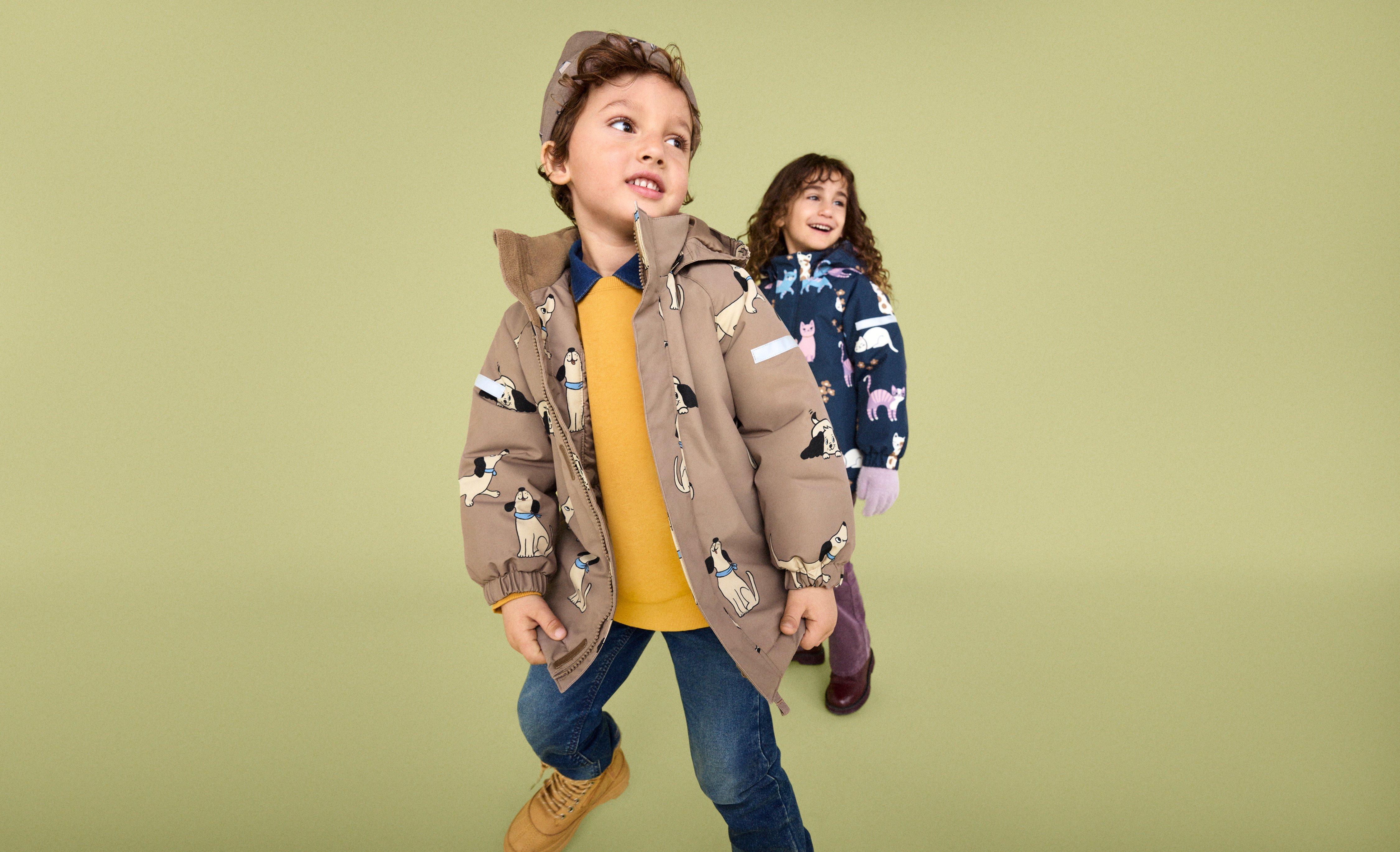 Two children playing with slime dressed in outerwear from Lindex.