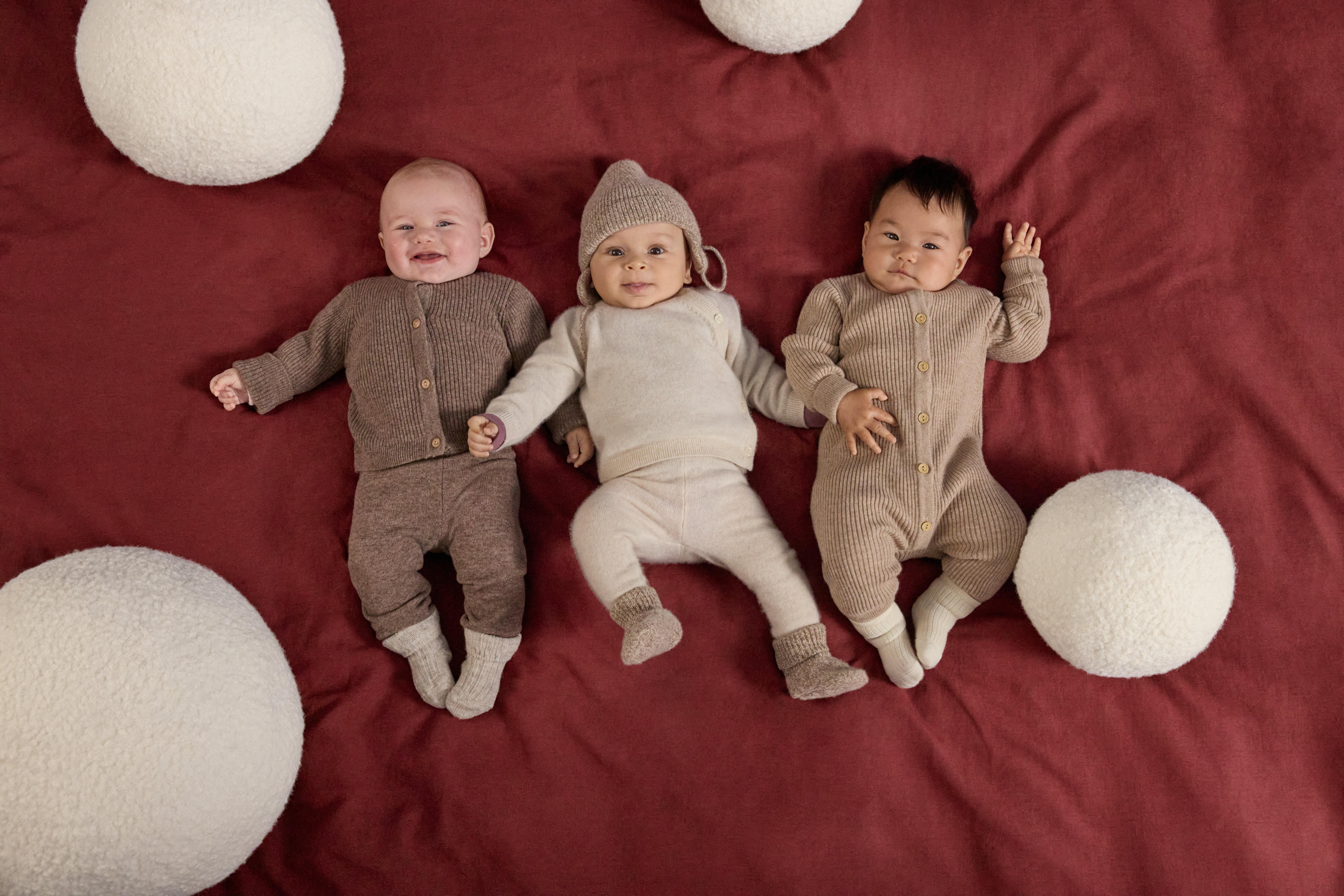 Three babies dressed in Premium quality garments.