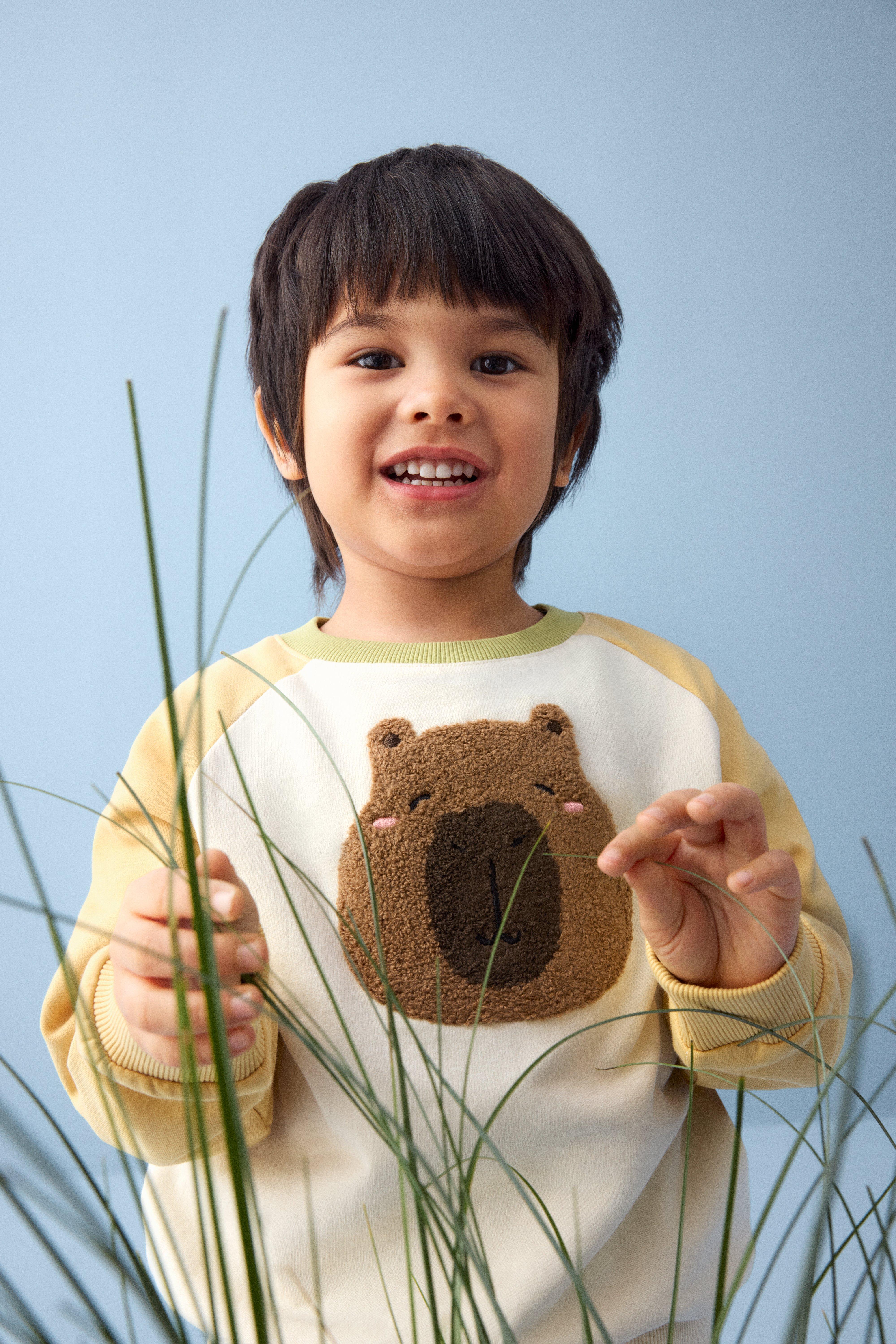 A girl agains a flower pattern.