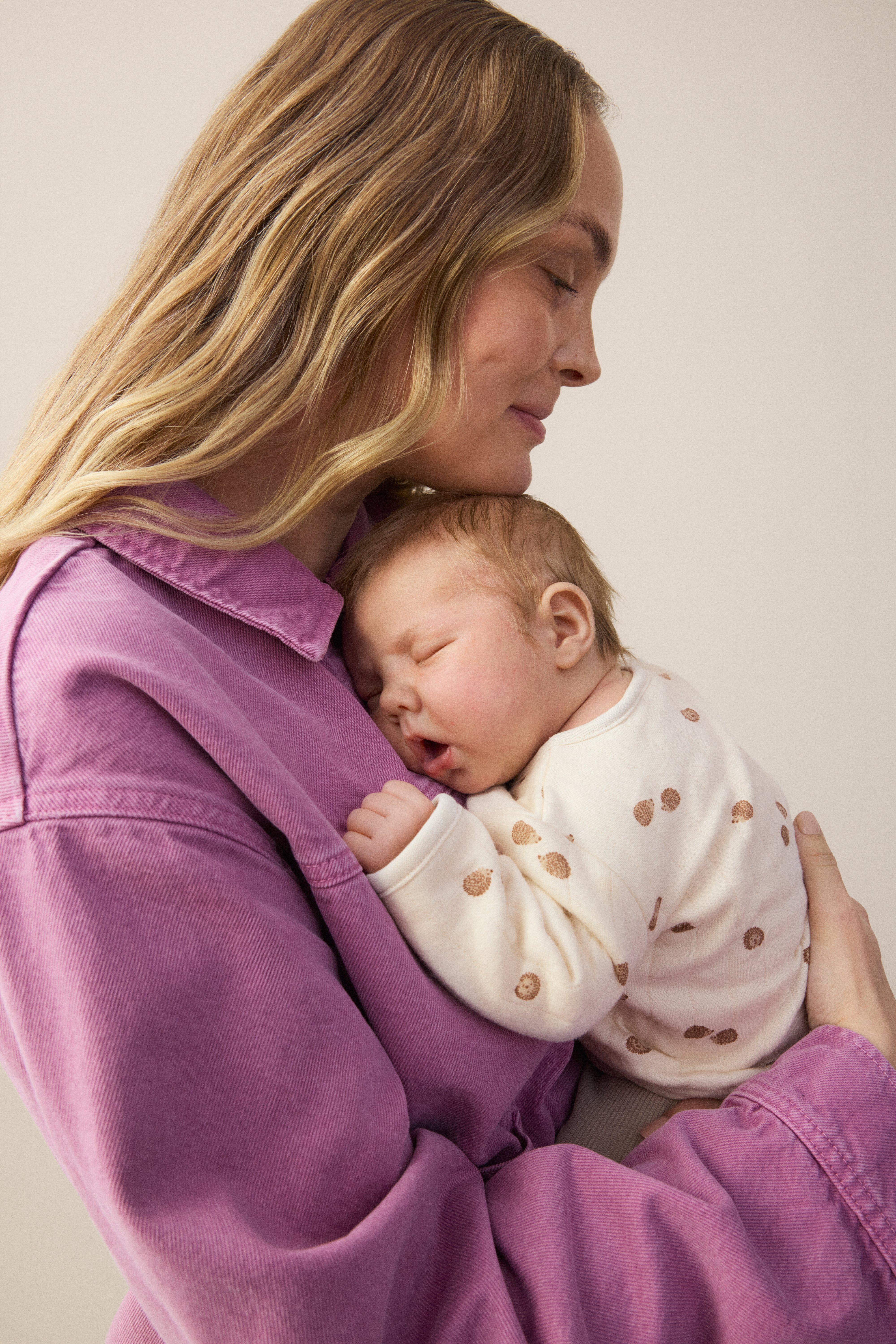 Woman with newborn in her arms 