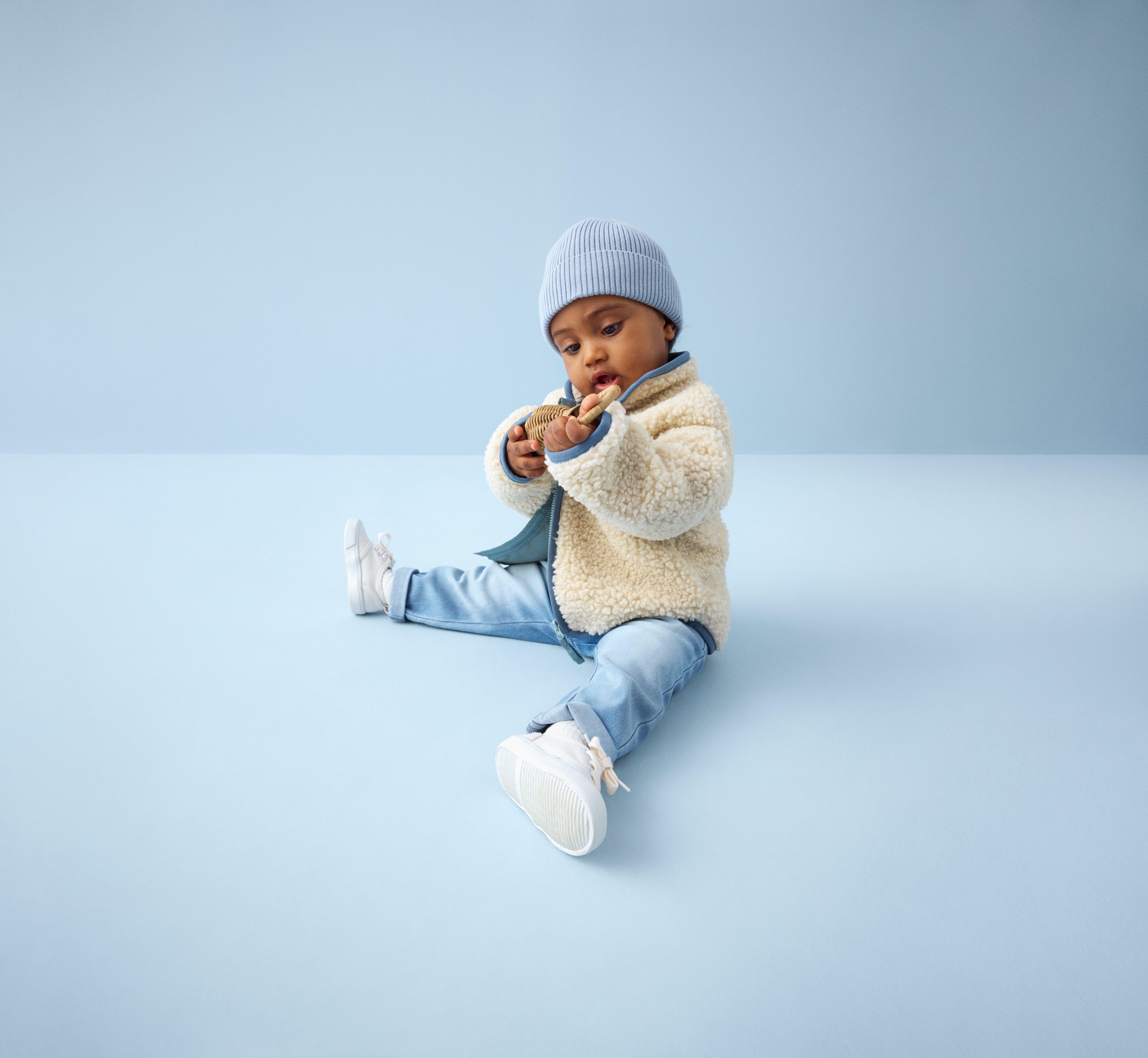 Two kids in lindex clothing laughing 