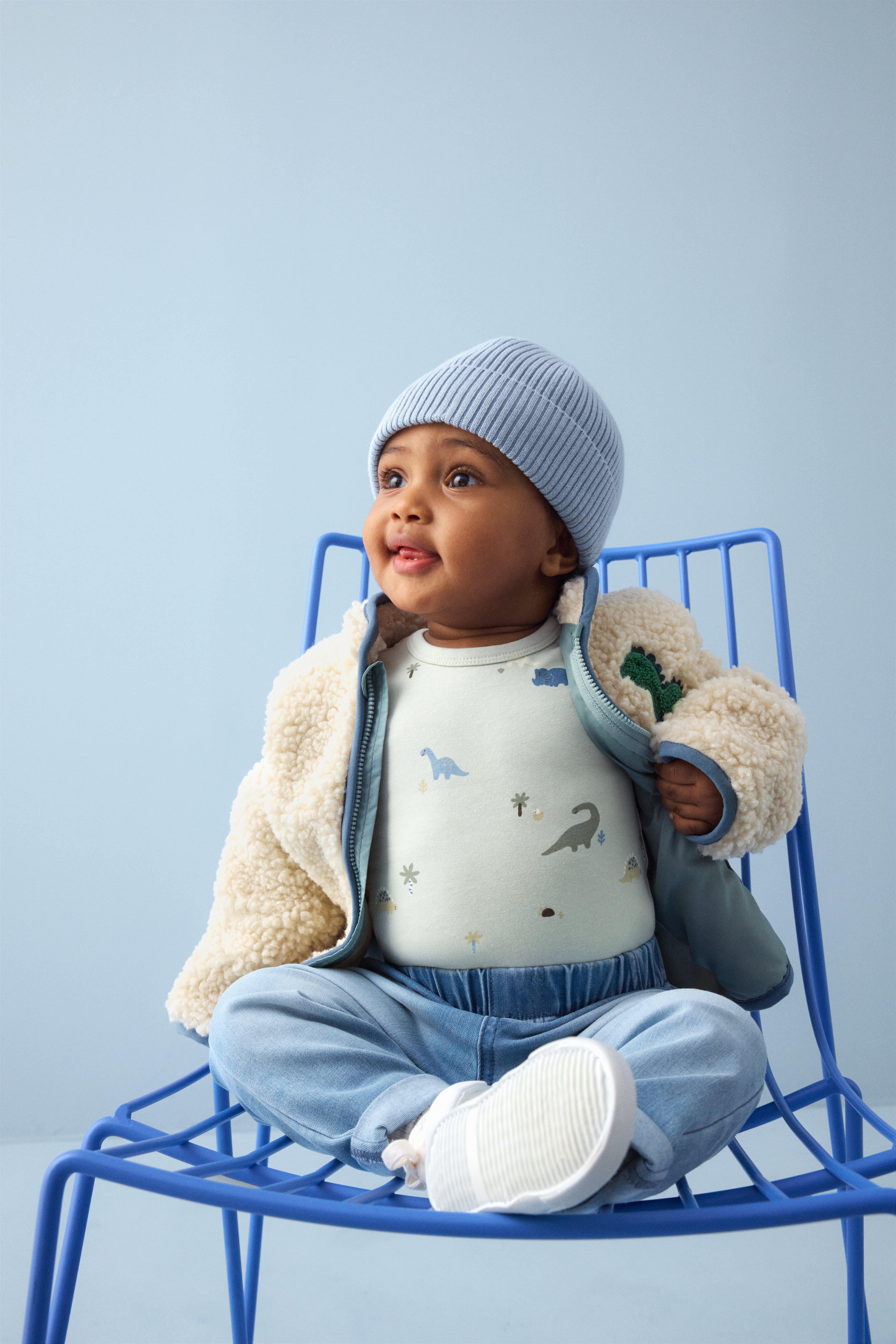 Baby in blue and white clothes