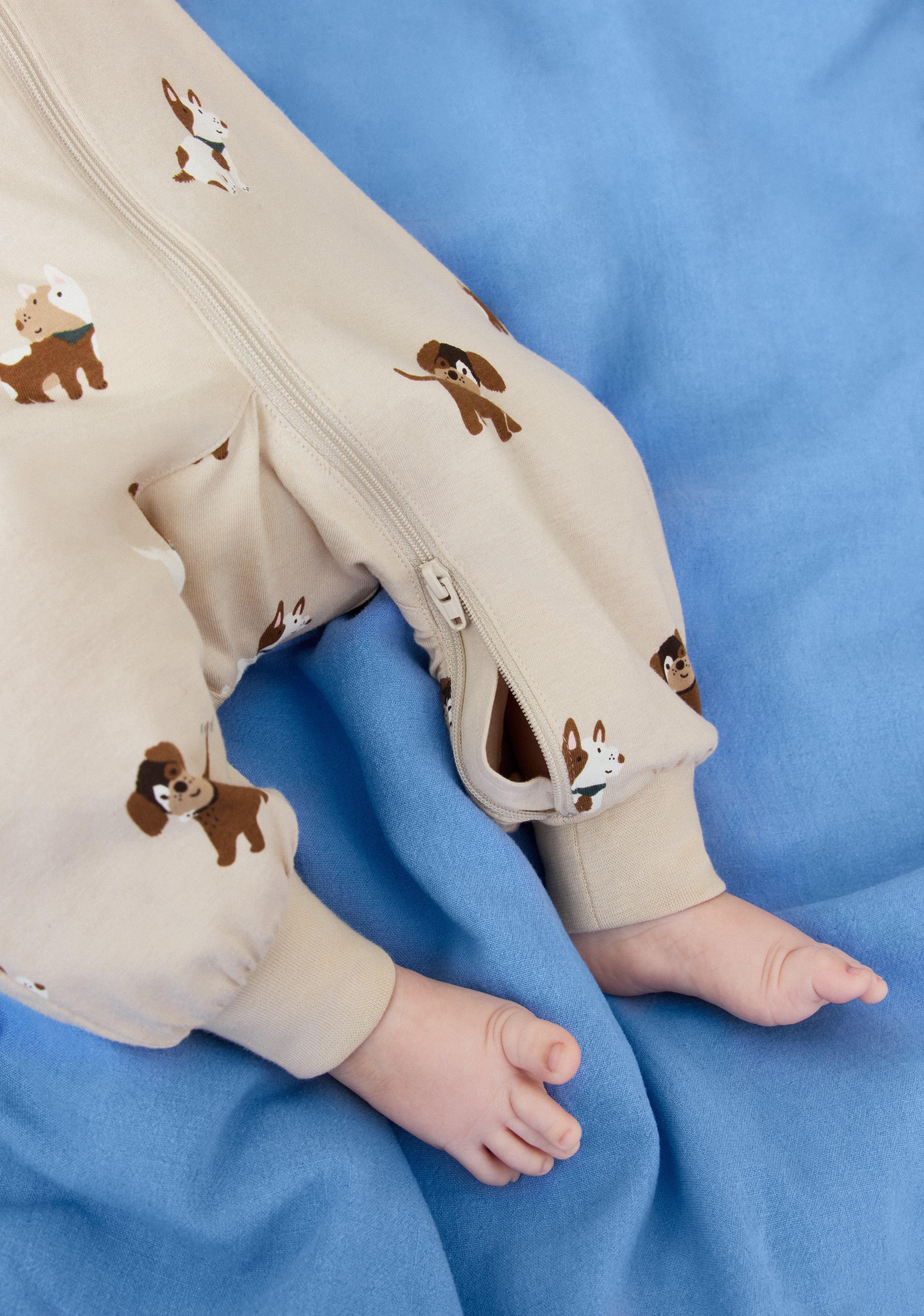 A baby pajama with a two-way zipper that opens from both the top and the bottom.