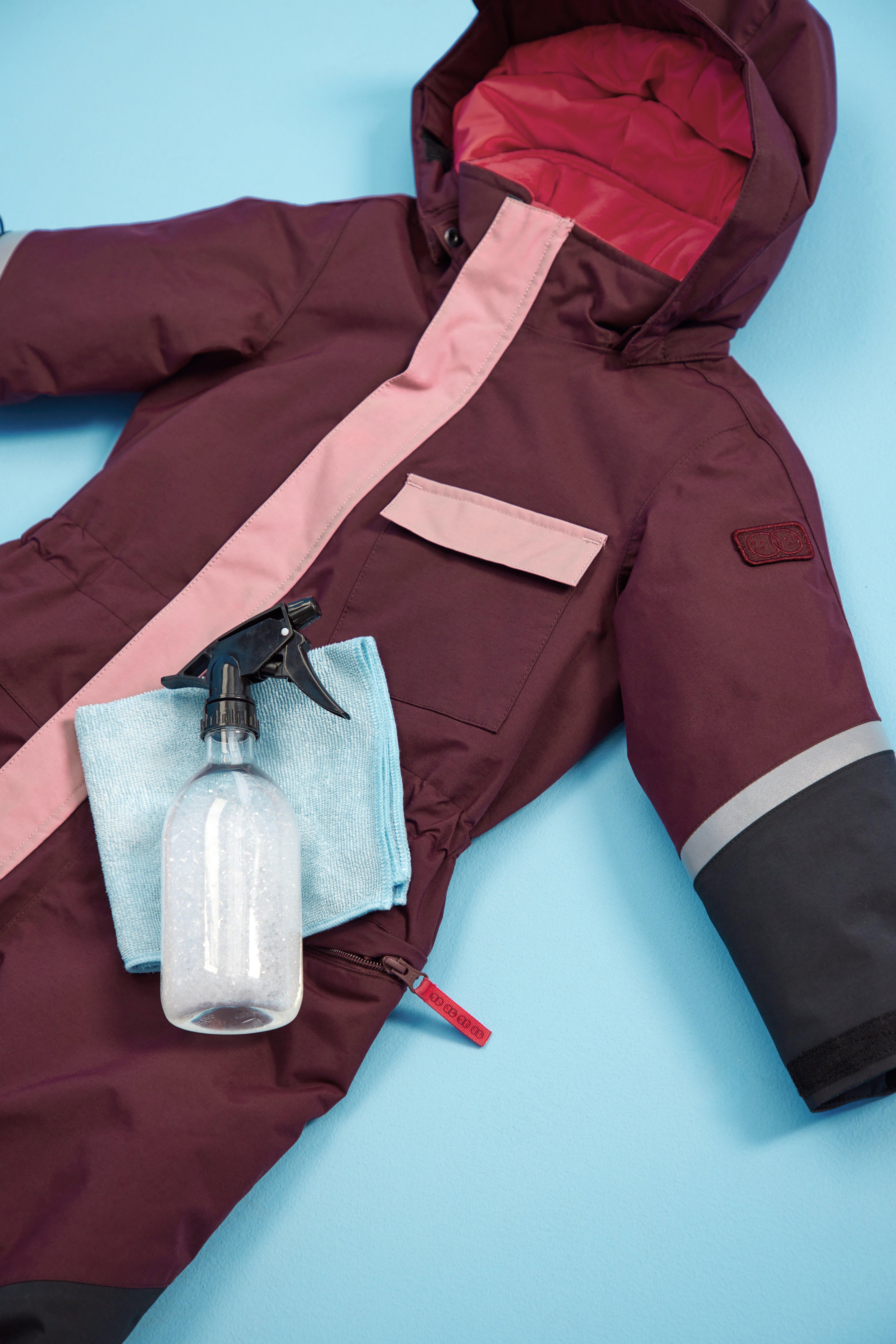 A washcloth and a bottle of cleaner.