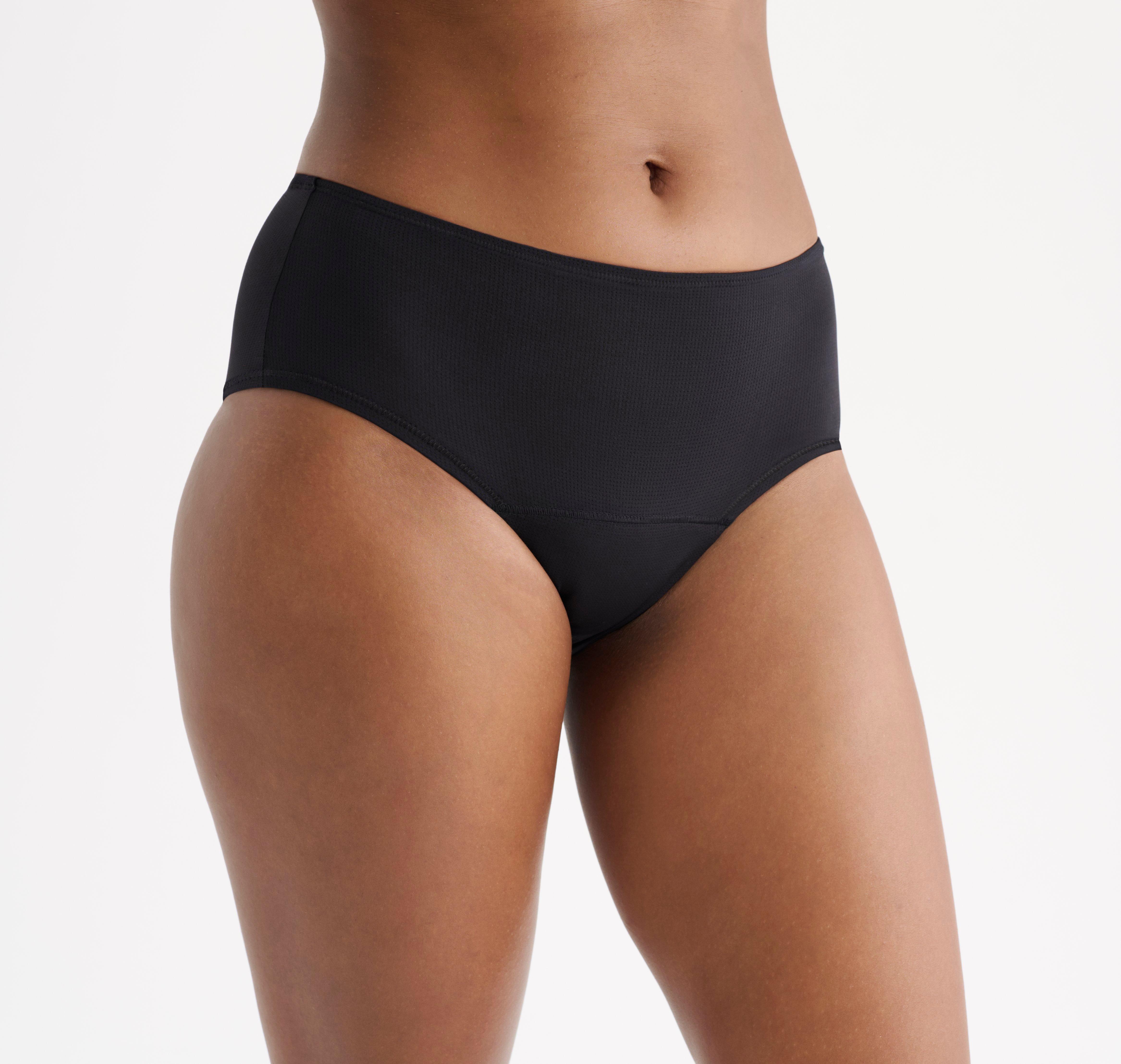 A woman wearing black period panties from Lindex.