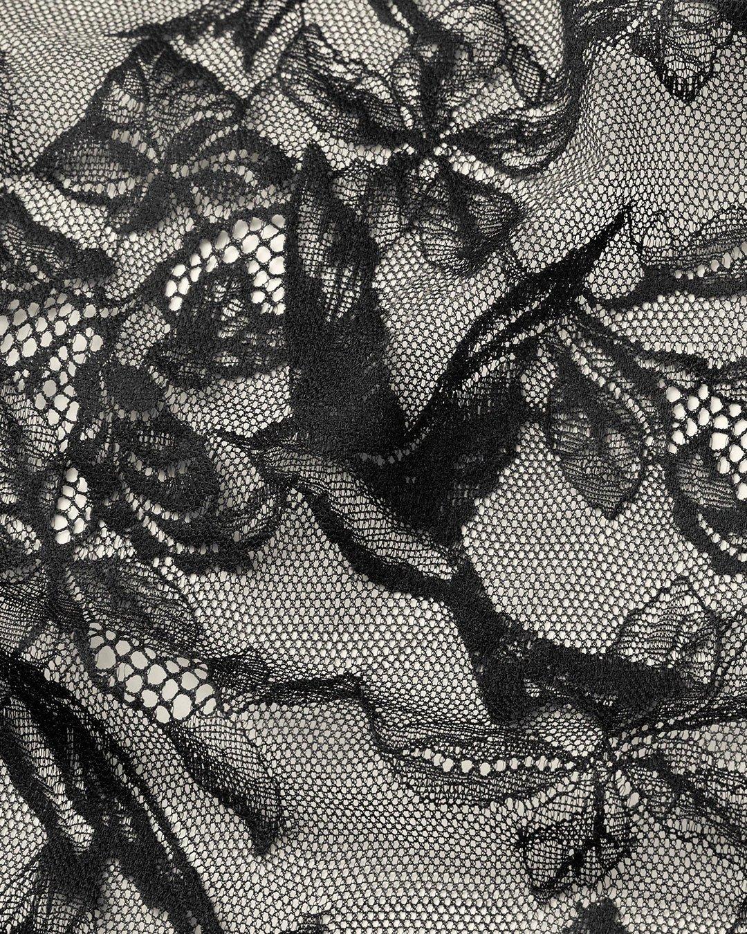 Närbild på svart spets med fågel design.