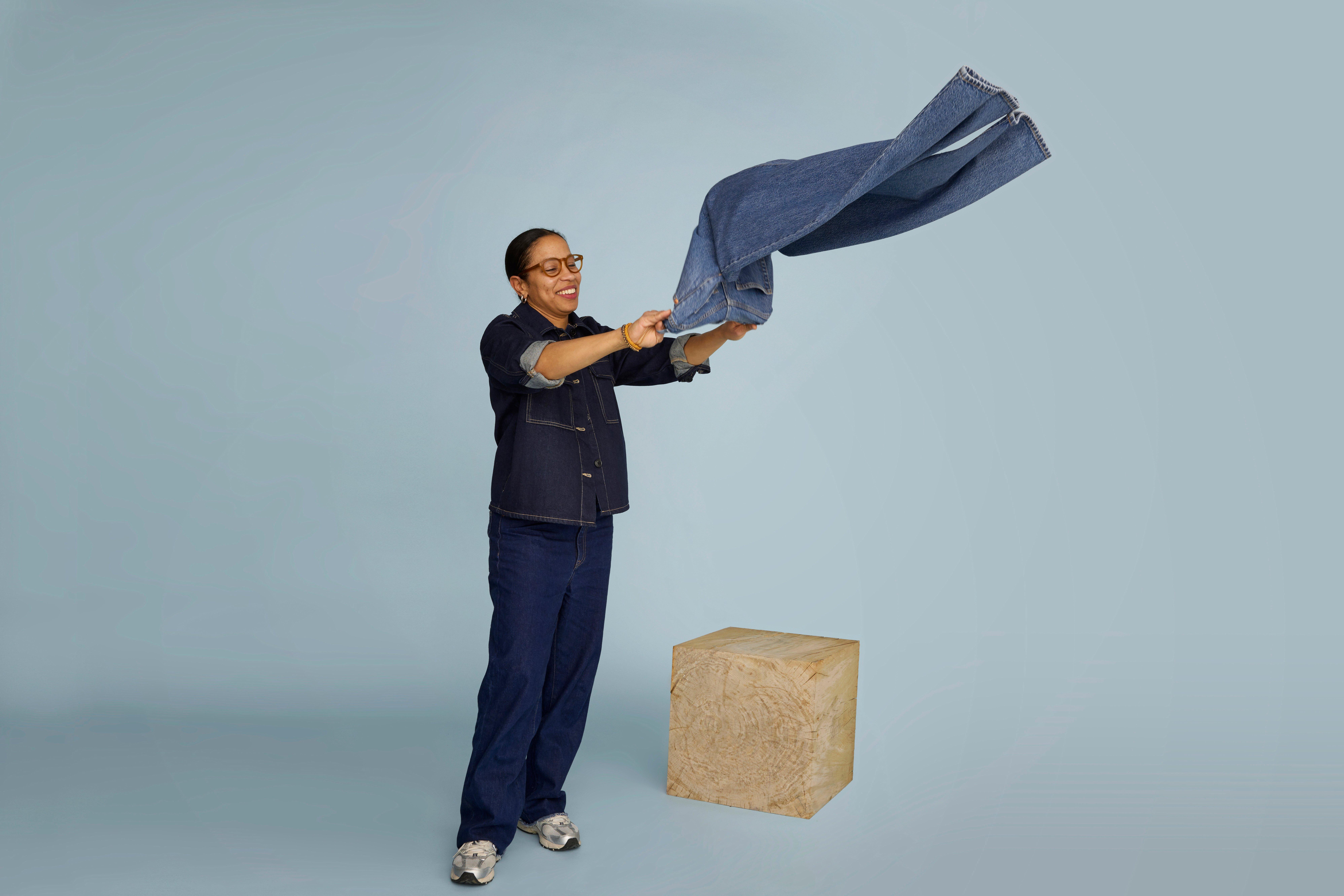  A picture of Suzana turning a pair of jeans.