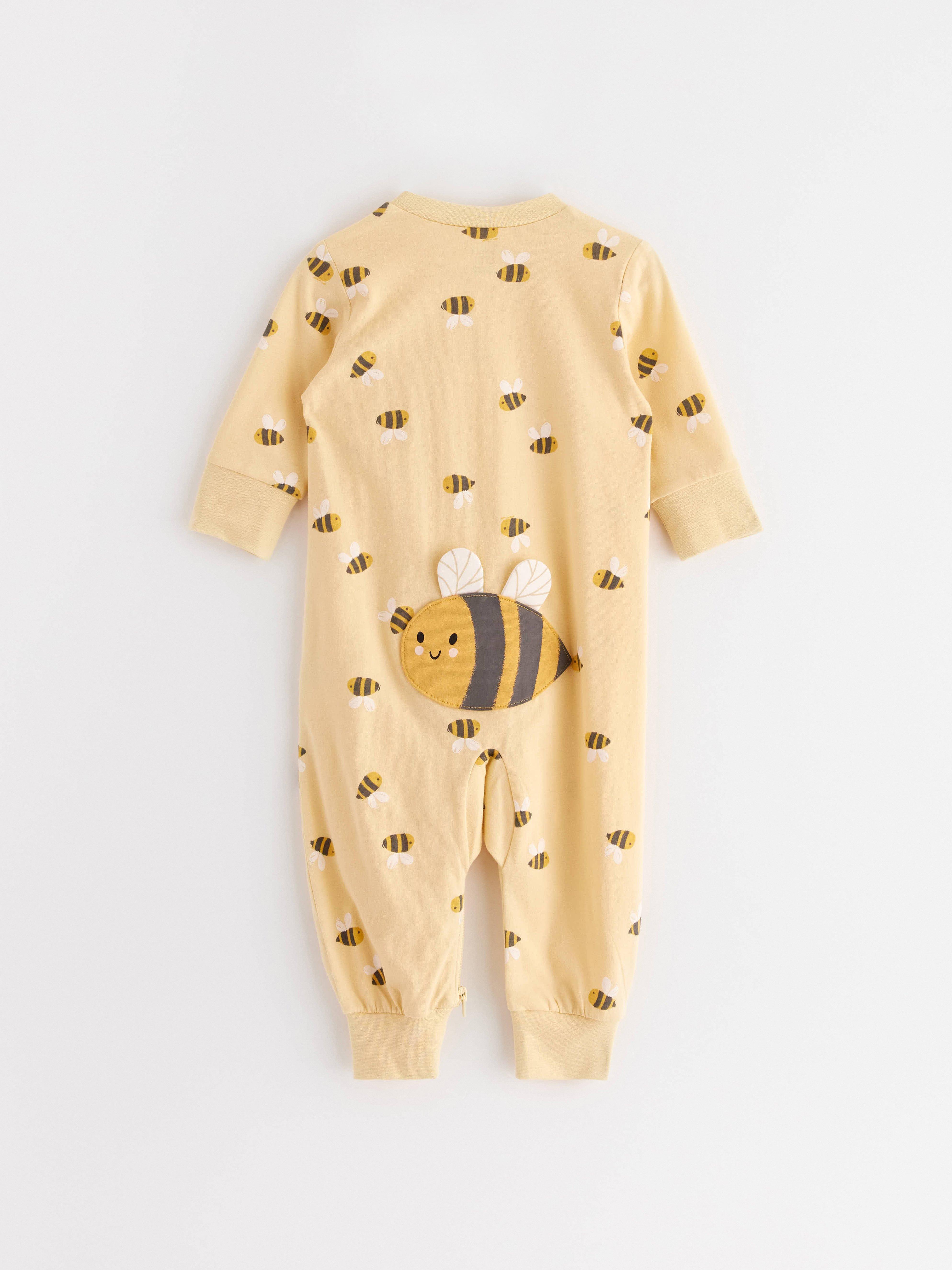  A picture of a yellow pajamas with a bee pattern.