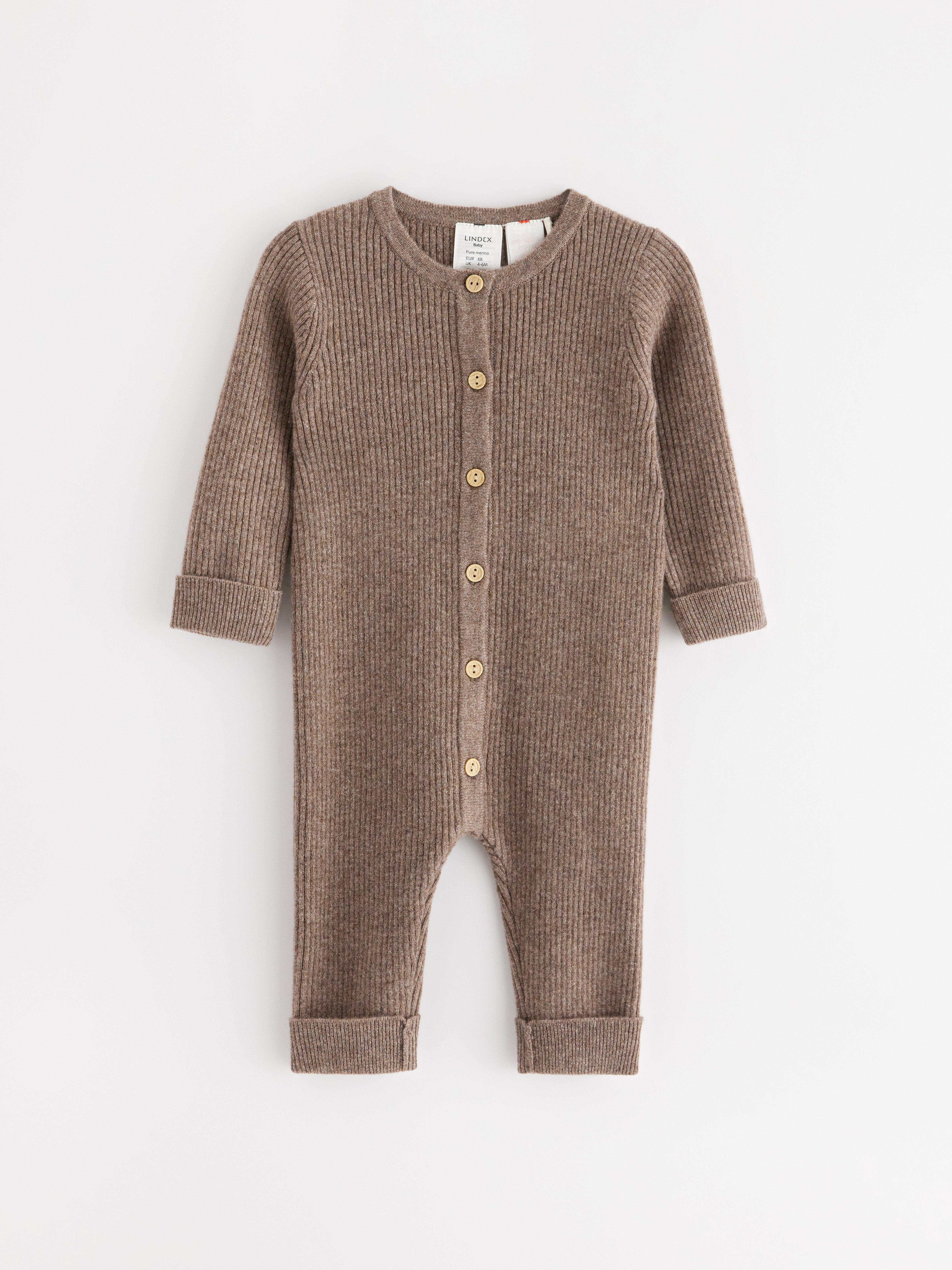 A brown ribbed jumpsuit in wool with buttons.