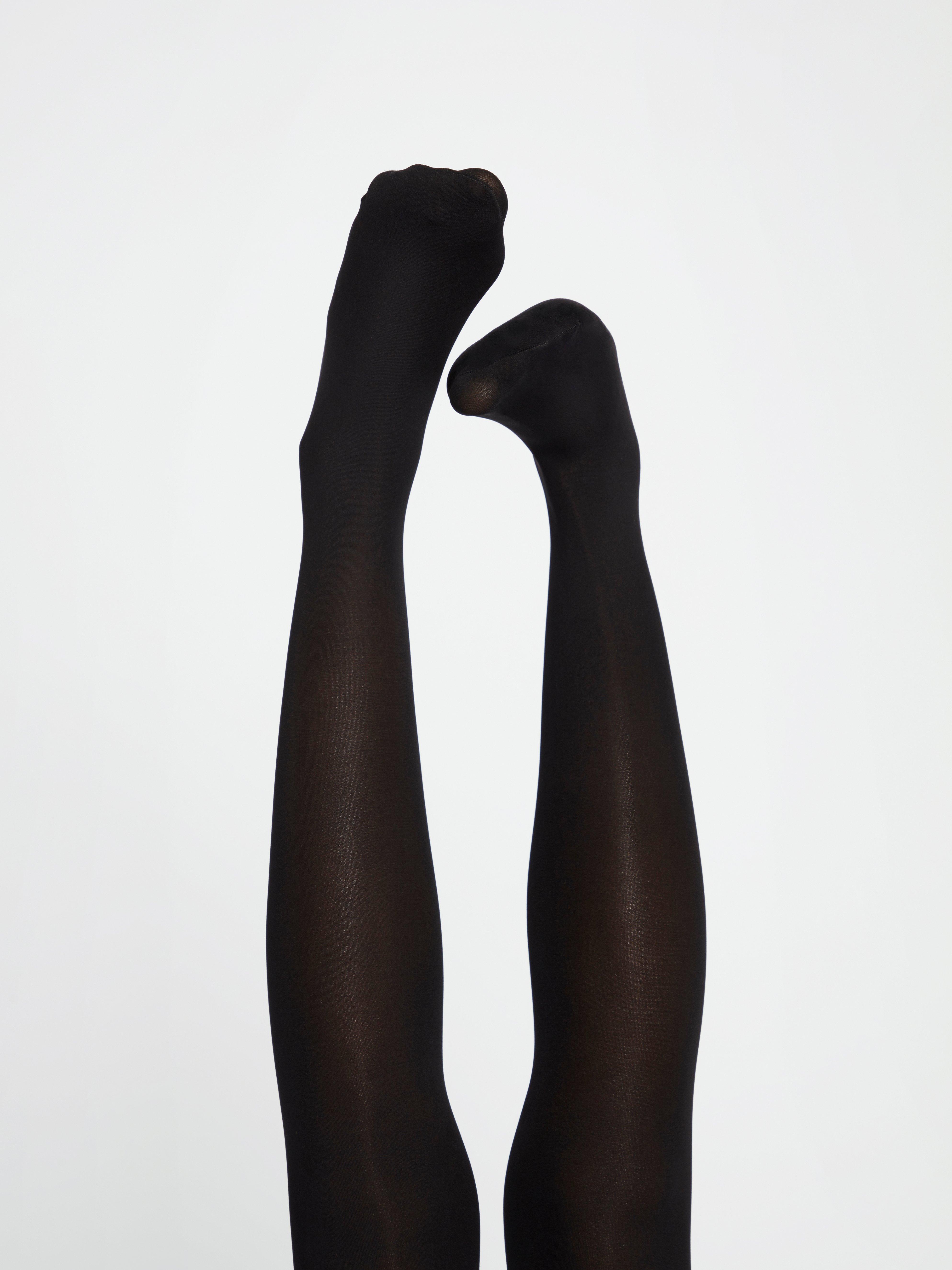 A woman in a pair of support tights from Lindex.