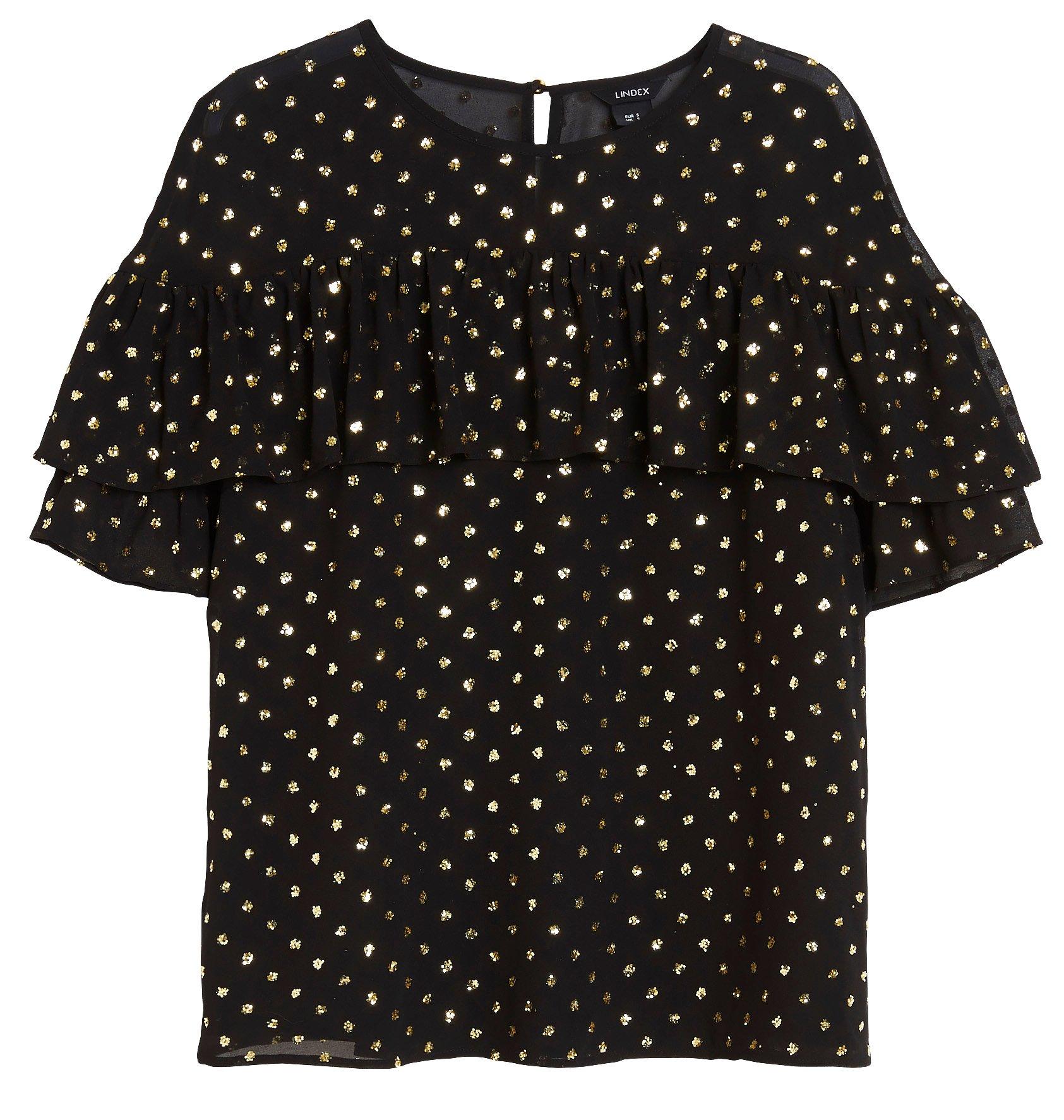 Glittrig blus med volang