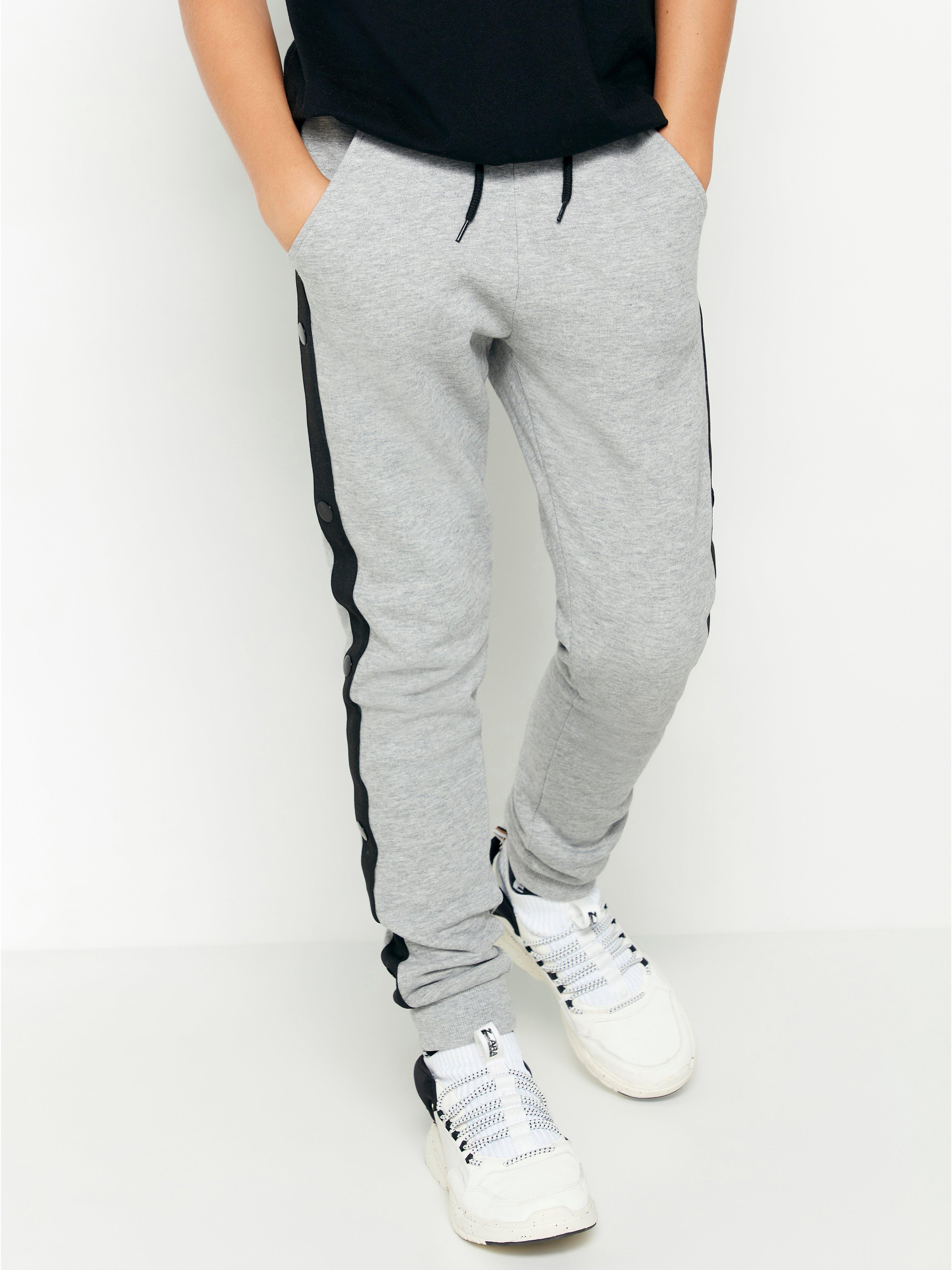 grey joggers with black stripe