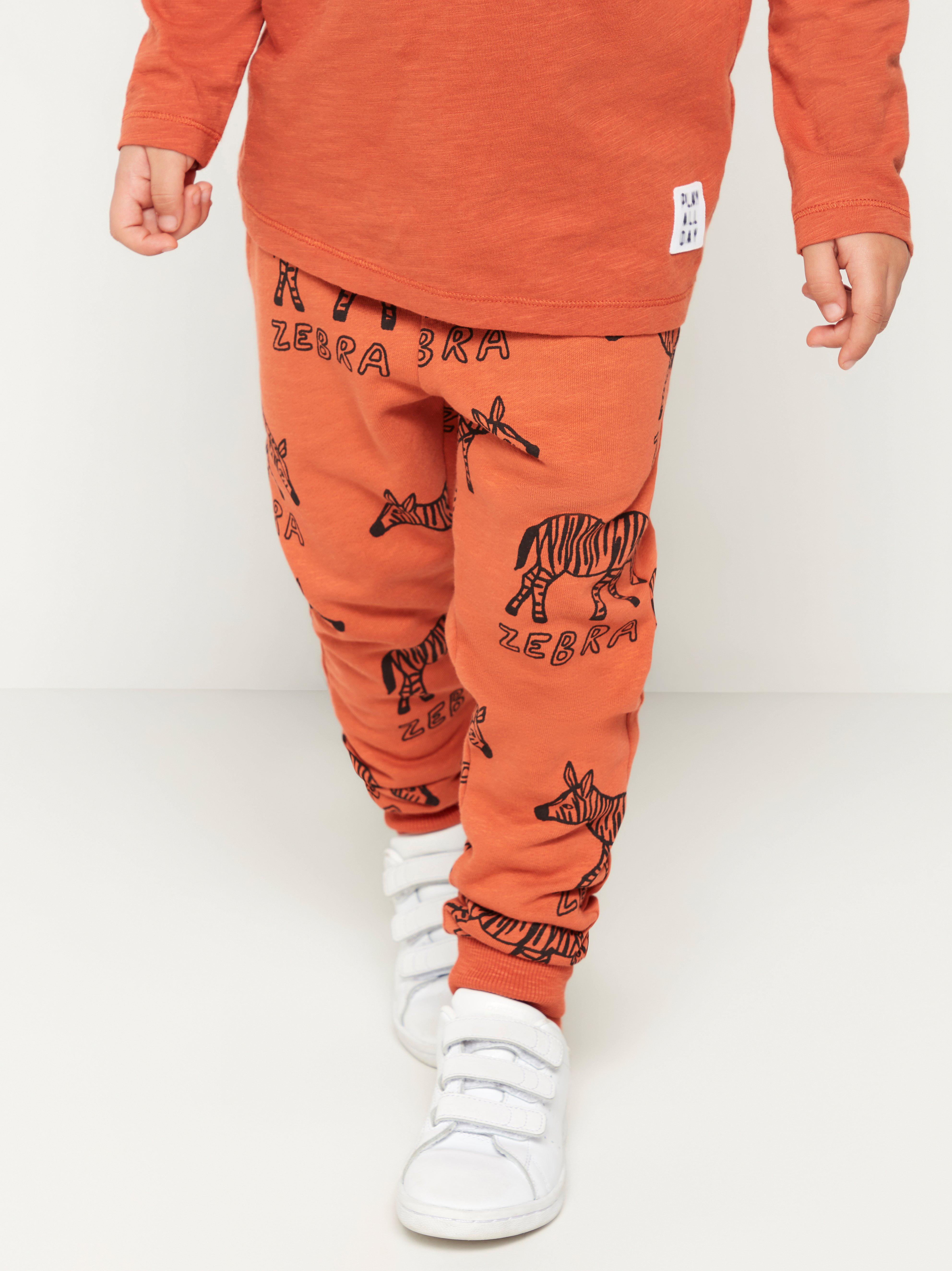 Dark orange sweatpants with zebras Lindex Latvia