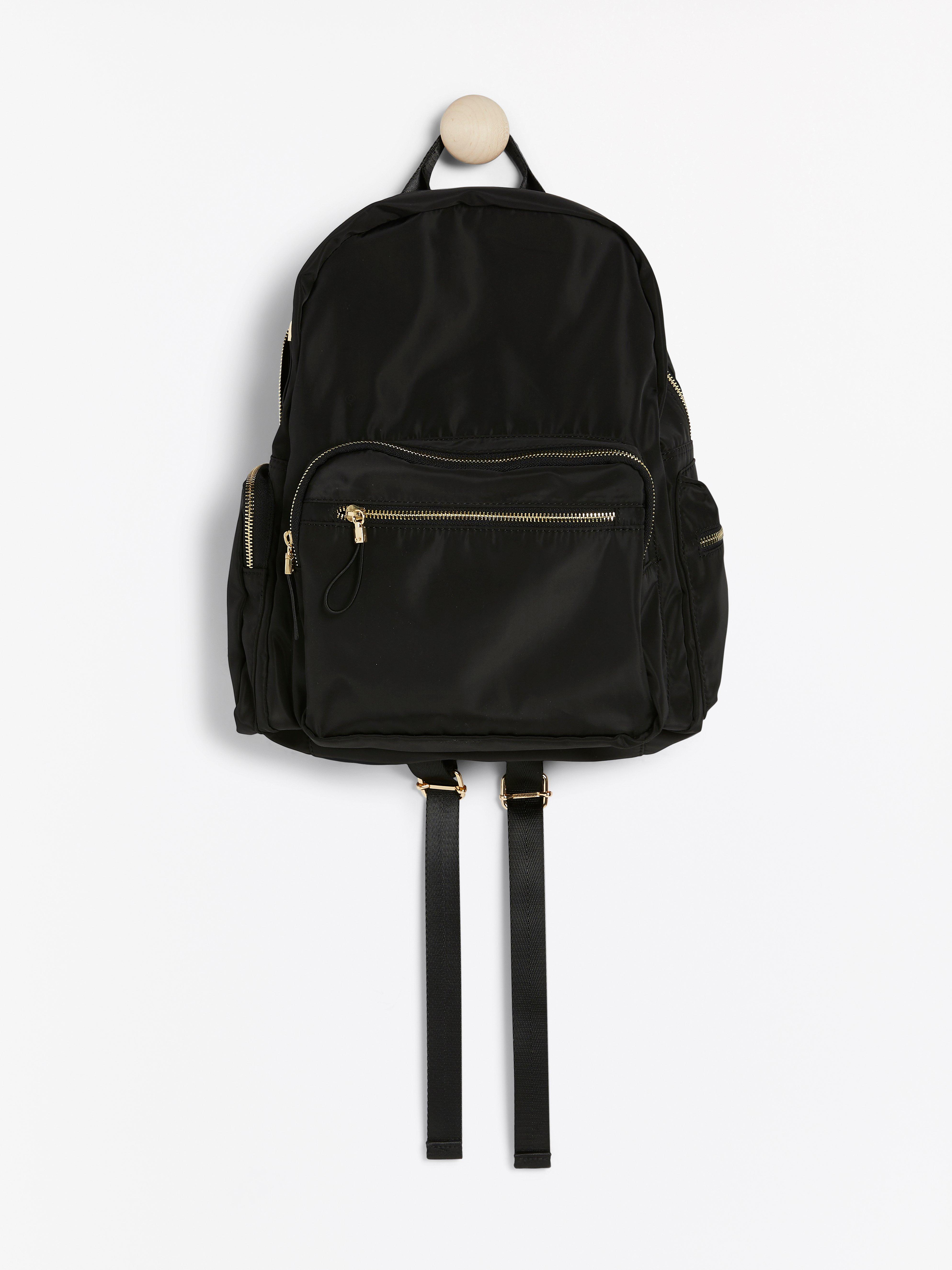 black backpack with gold zippers