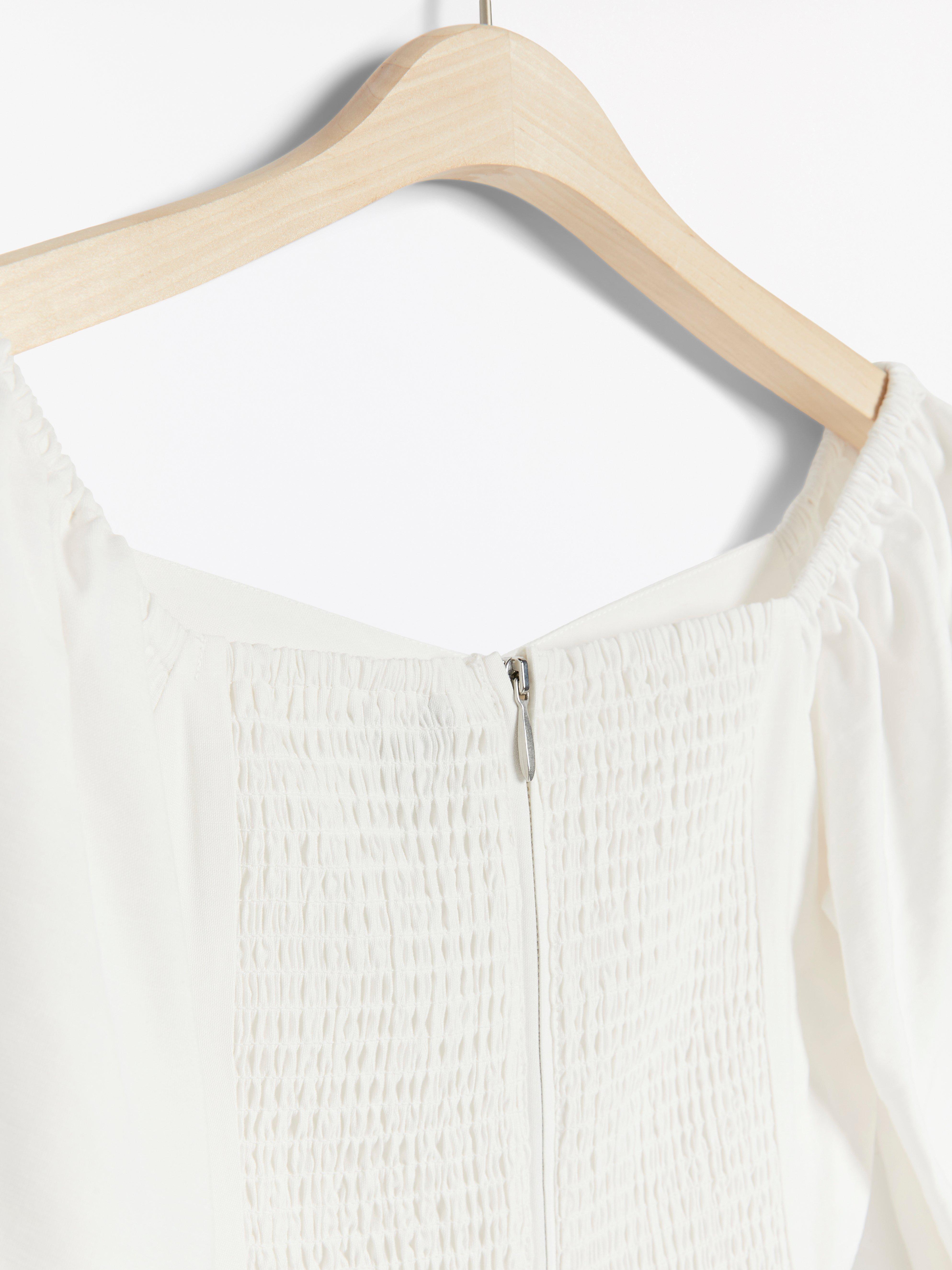 white shoulderless blouse