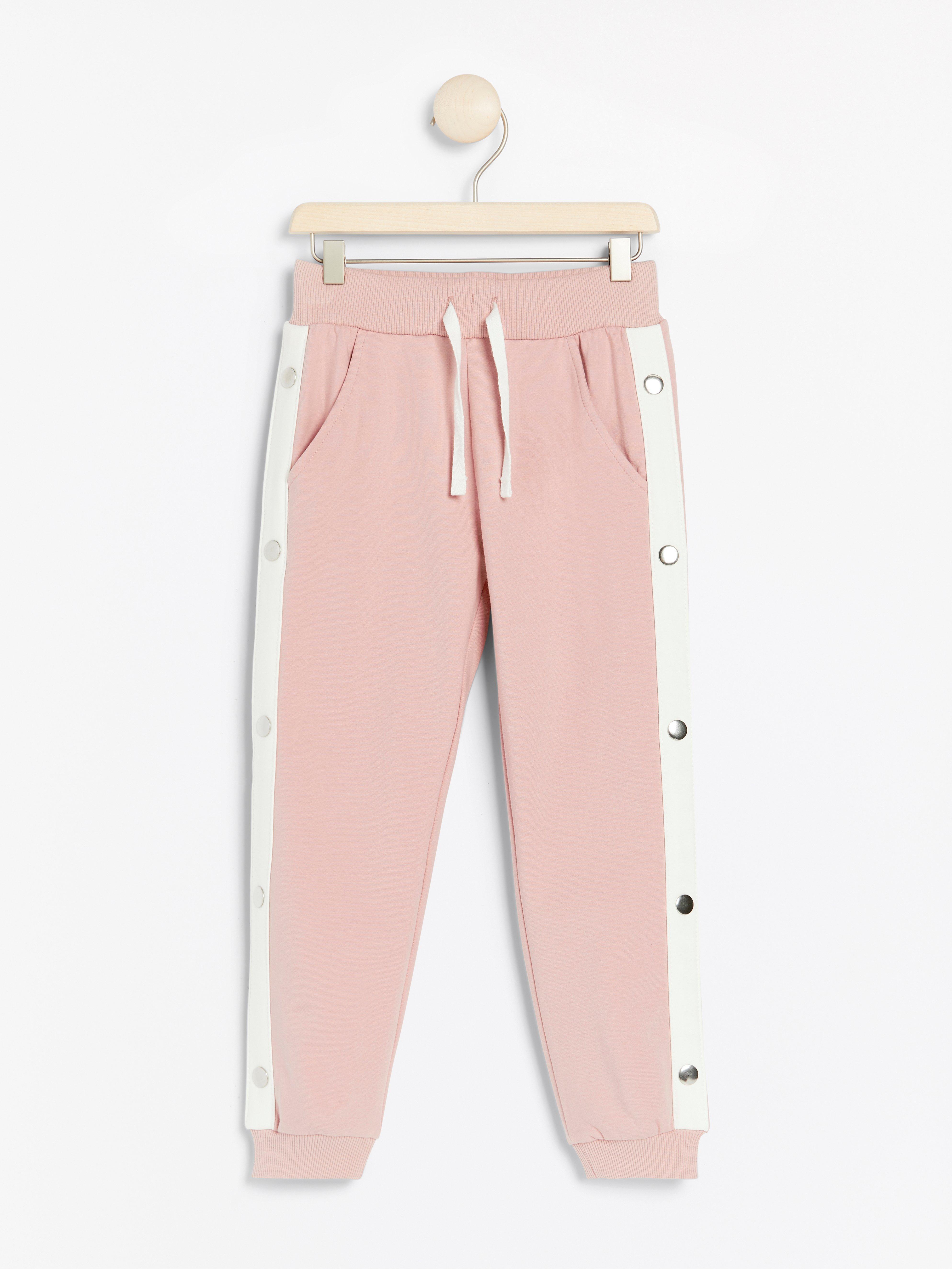 pink joggers with white stripe