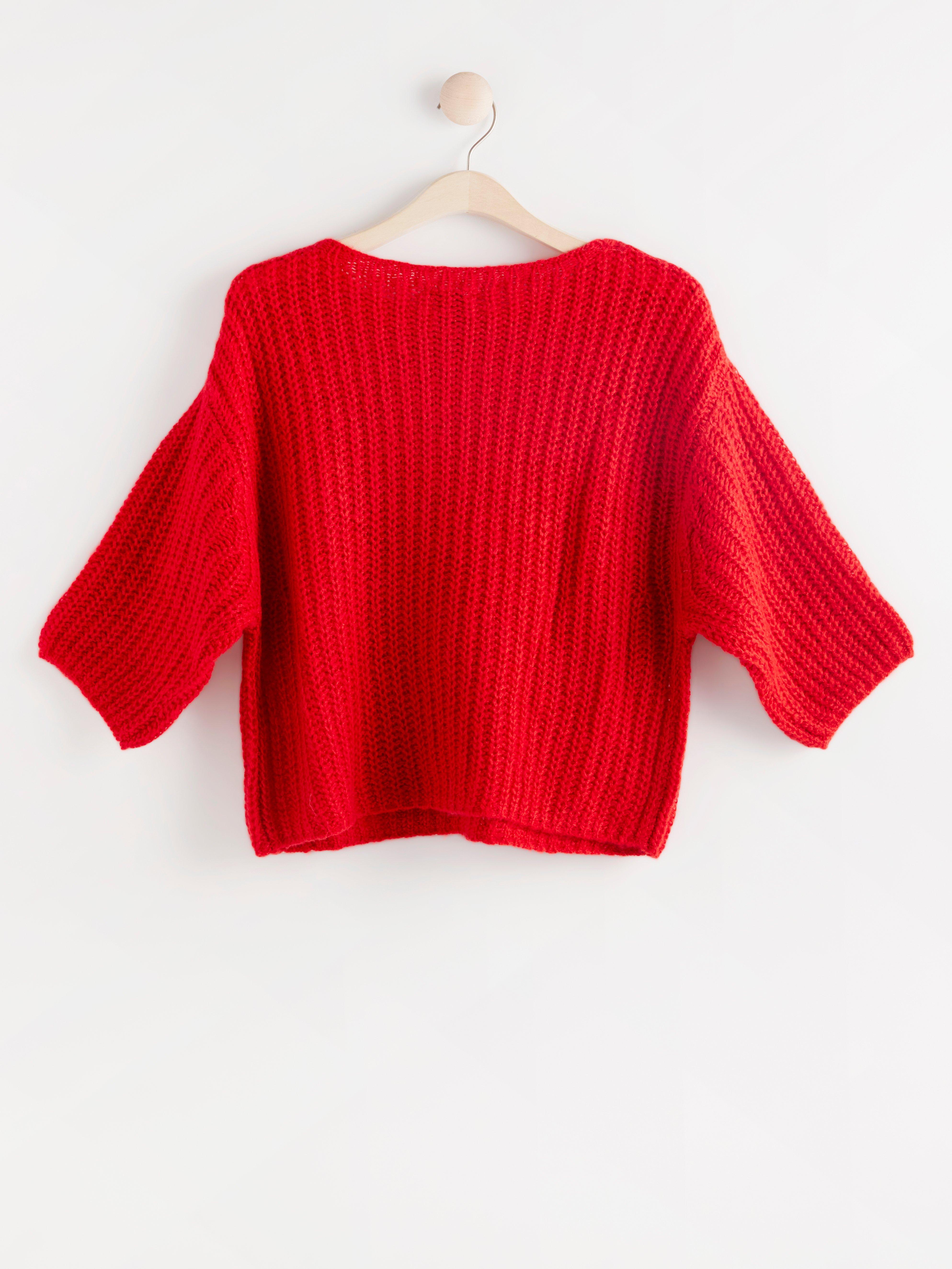 red knitted jumper