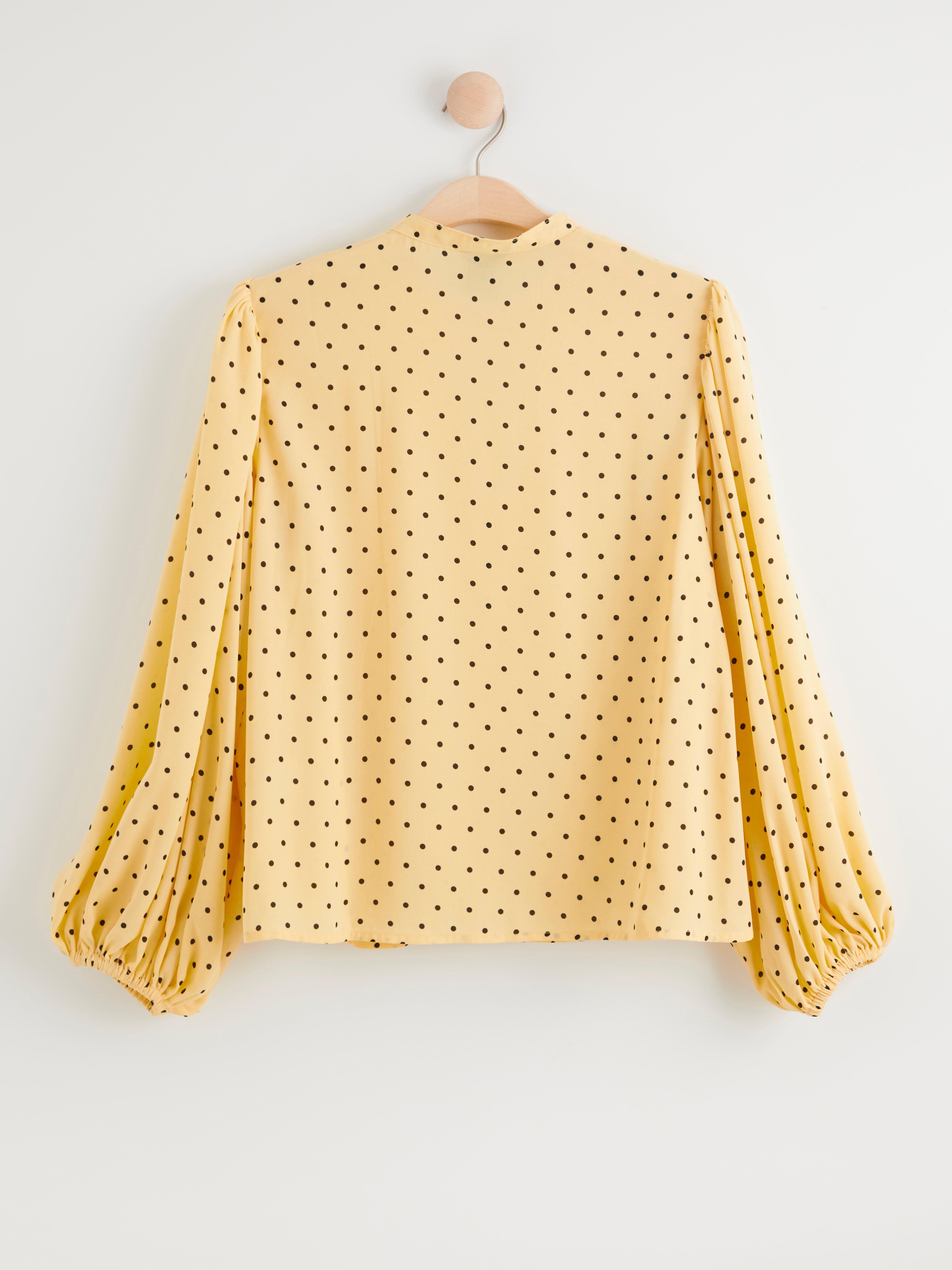 yellow patterned blouse