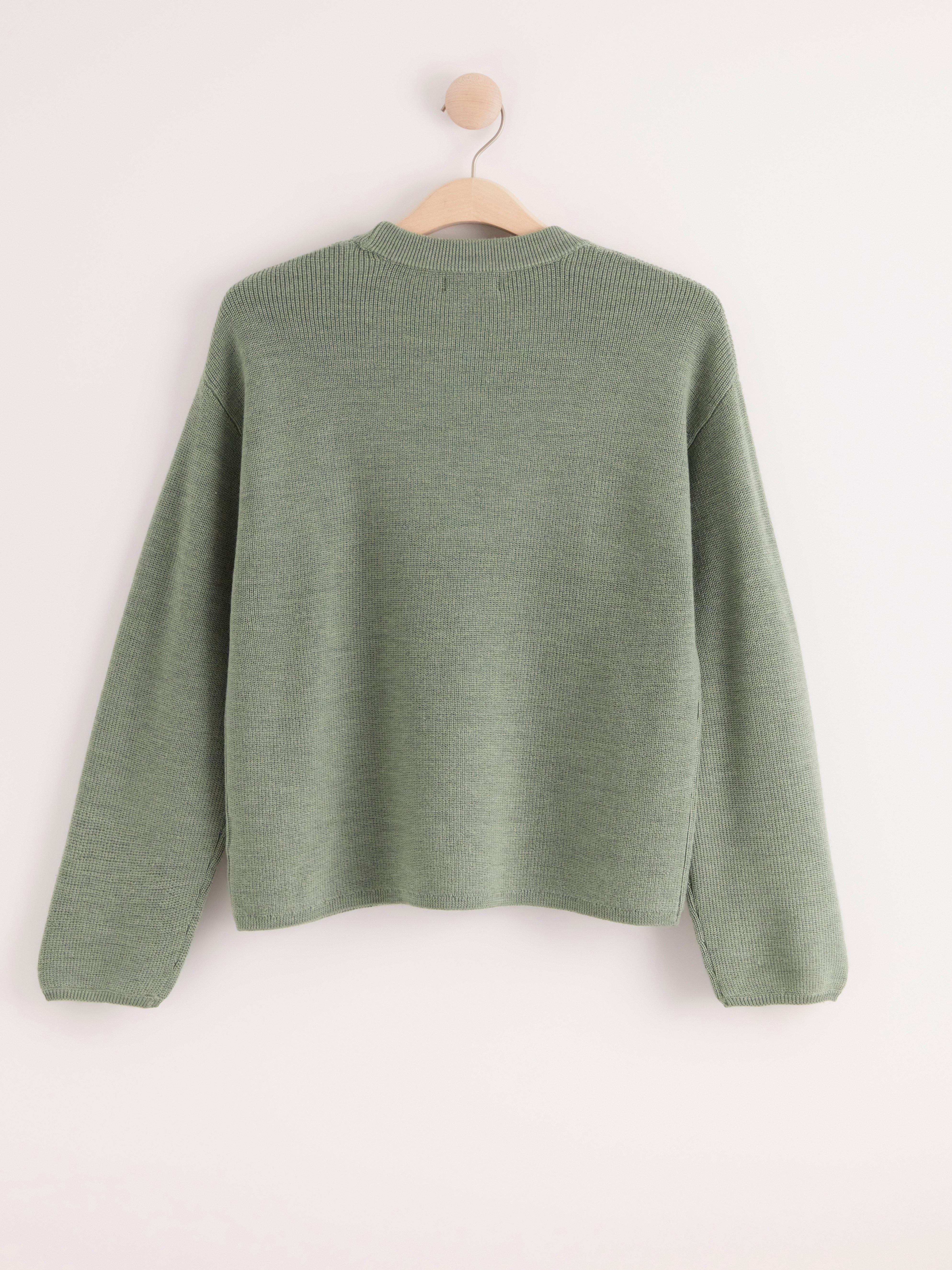 green woolen jumper