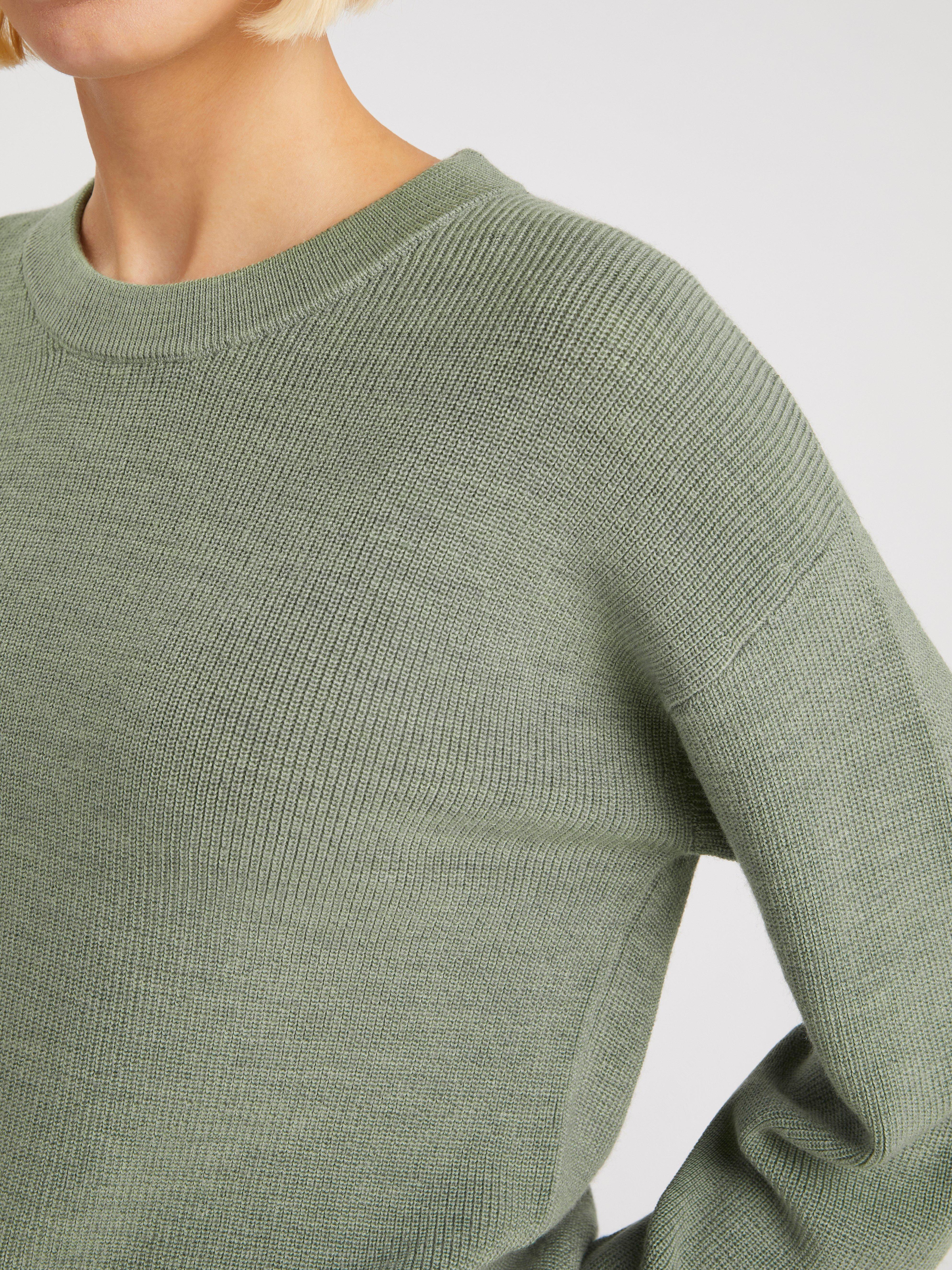 green woolen jumper