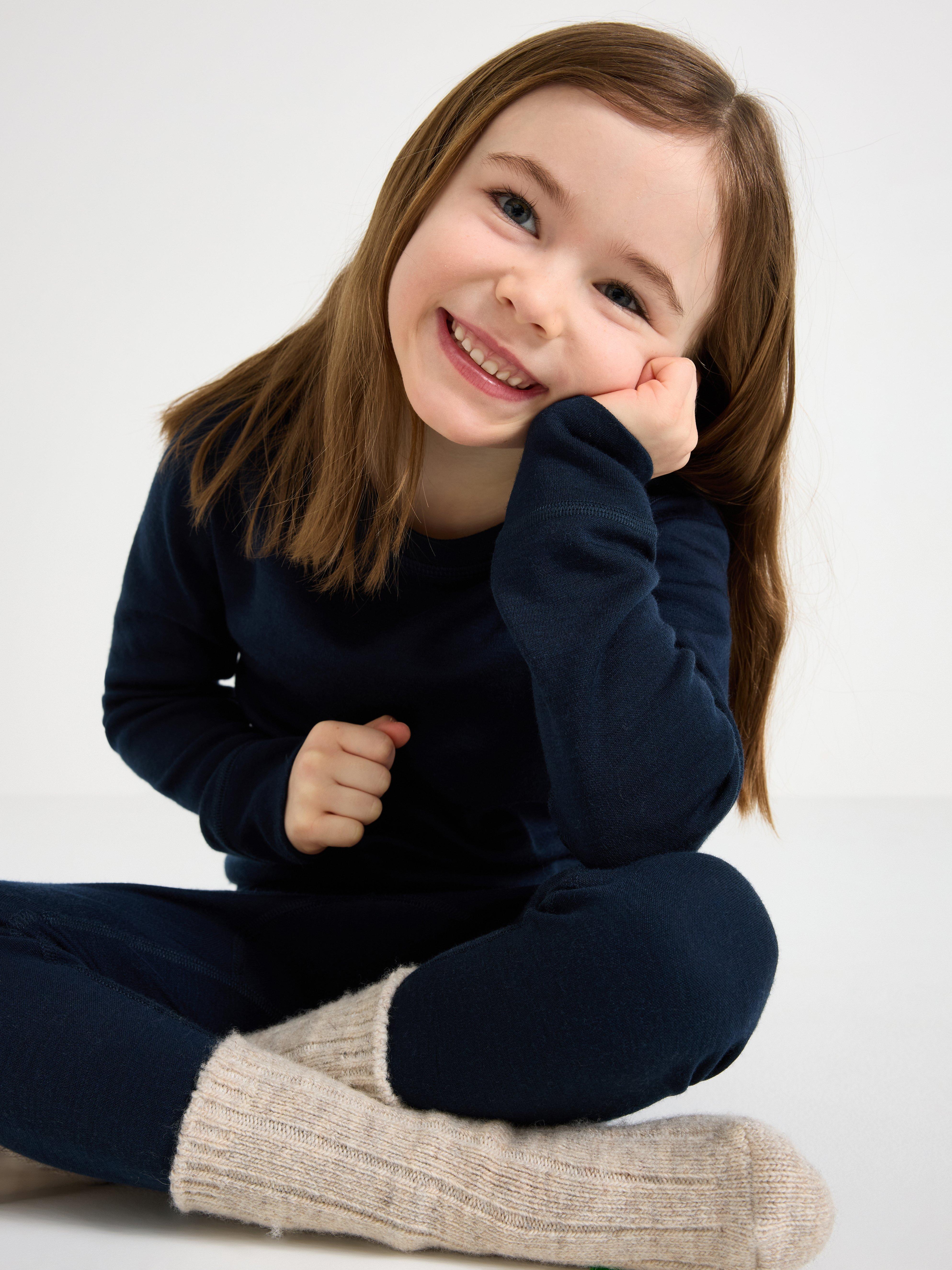 A girl wearing a brown merino wool undergarment
