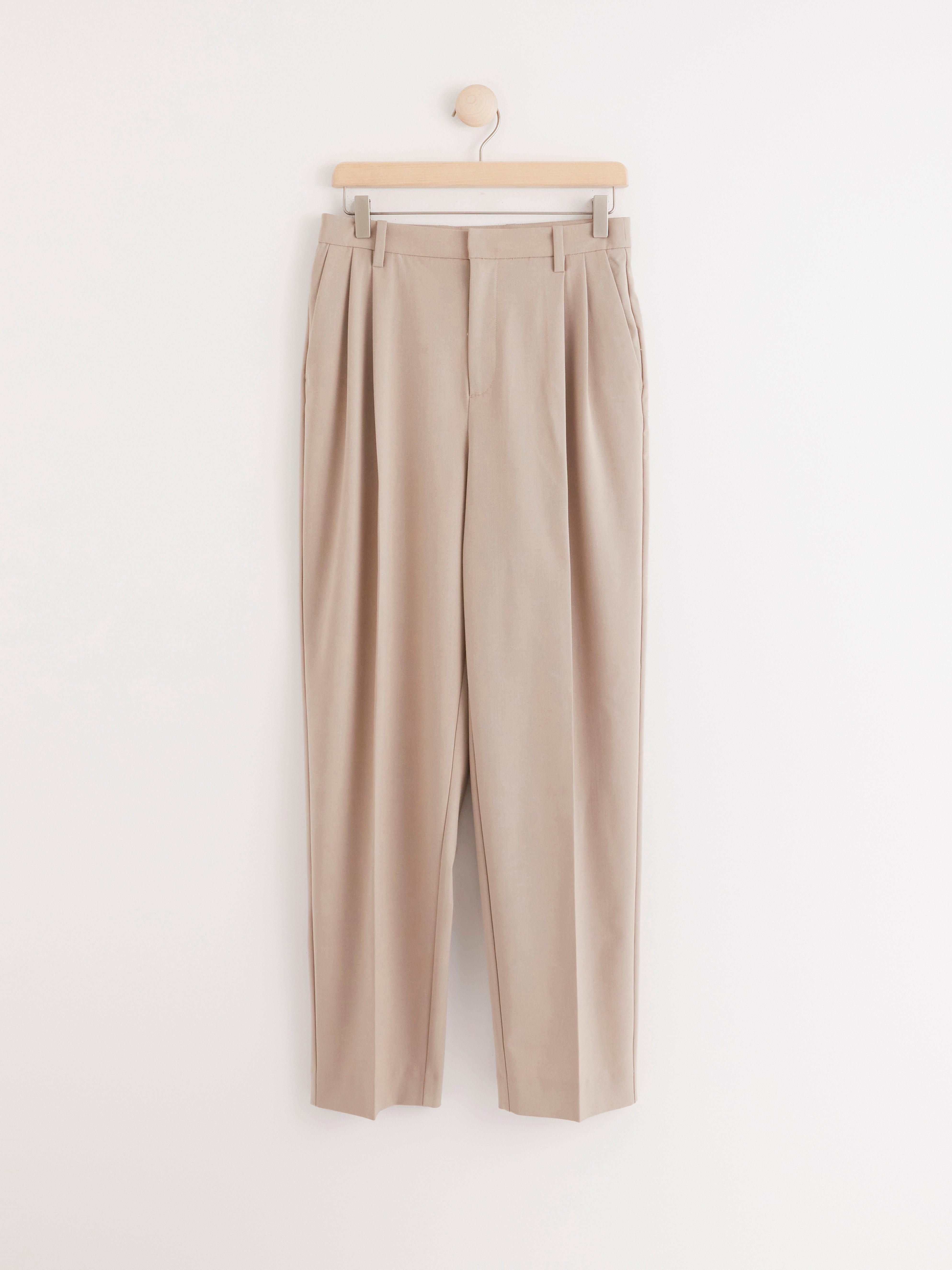 beige tapered trousers