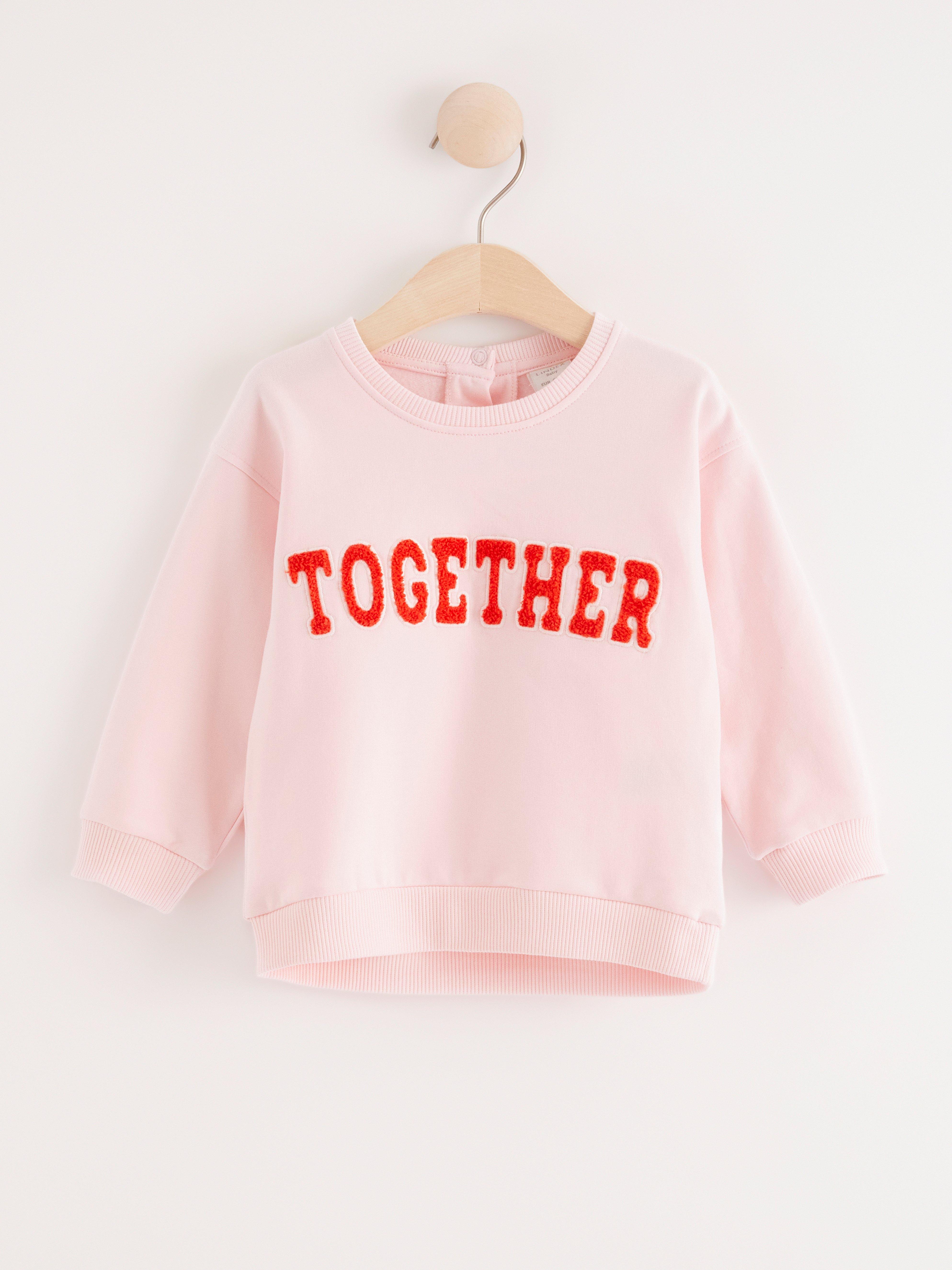 Sweatshirt med text