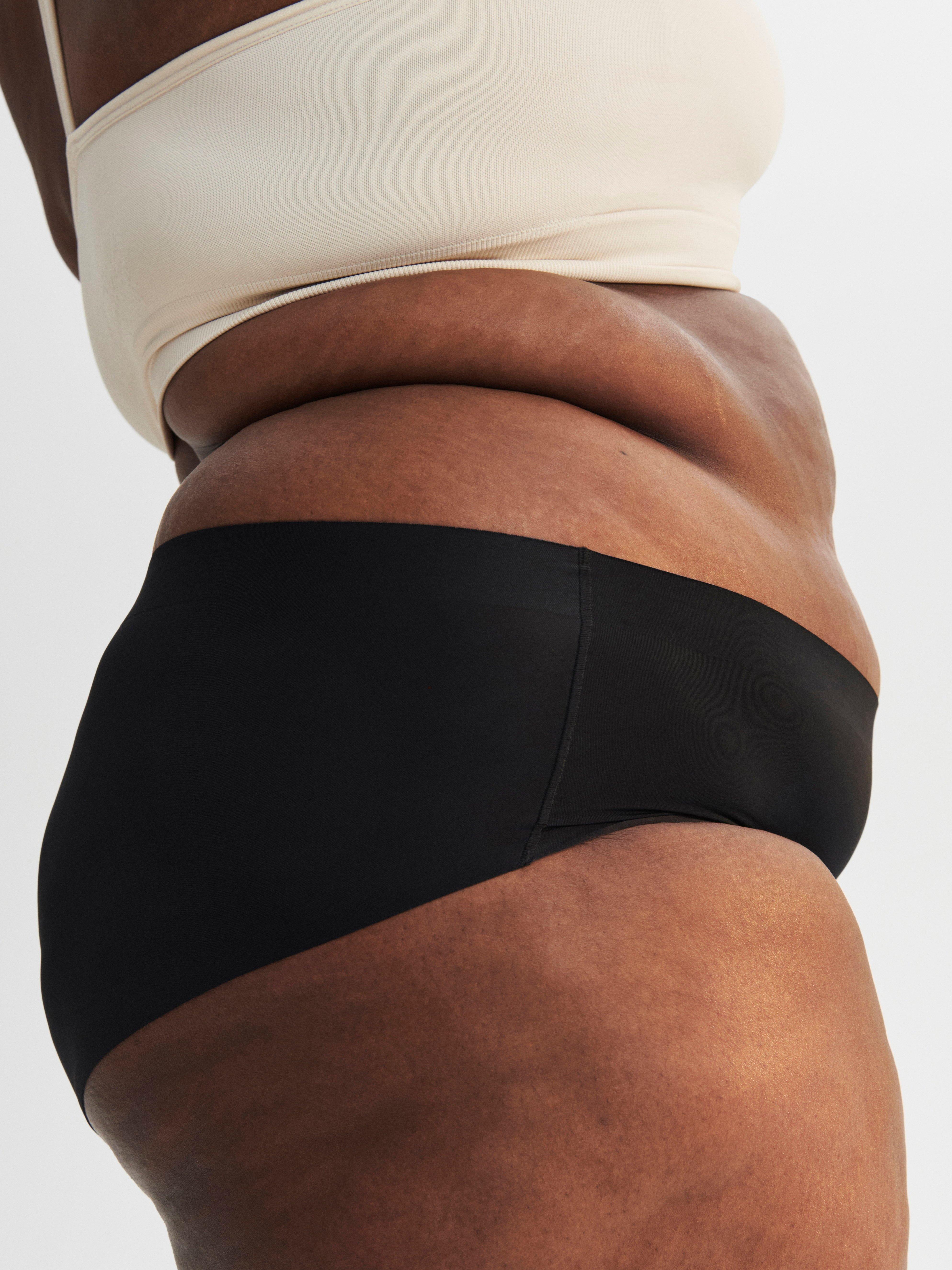 A woman in a pair of black hiphugger period-proof panties.