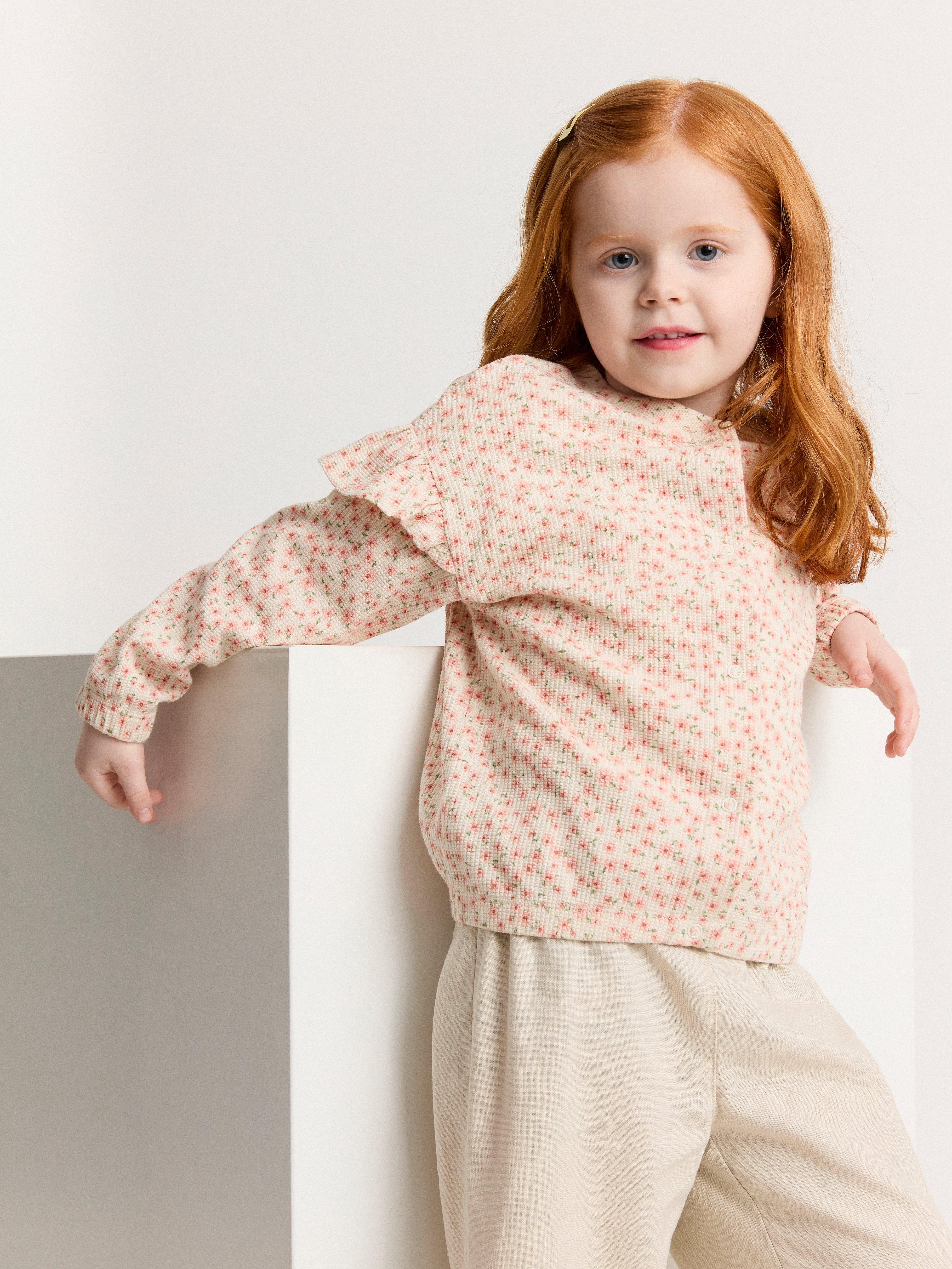 Cardigan med volang på axeln