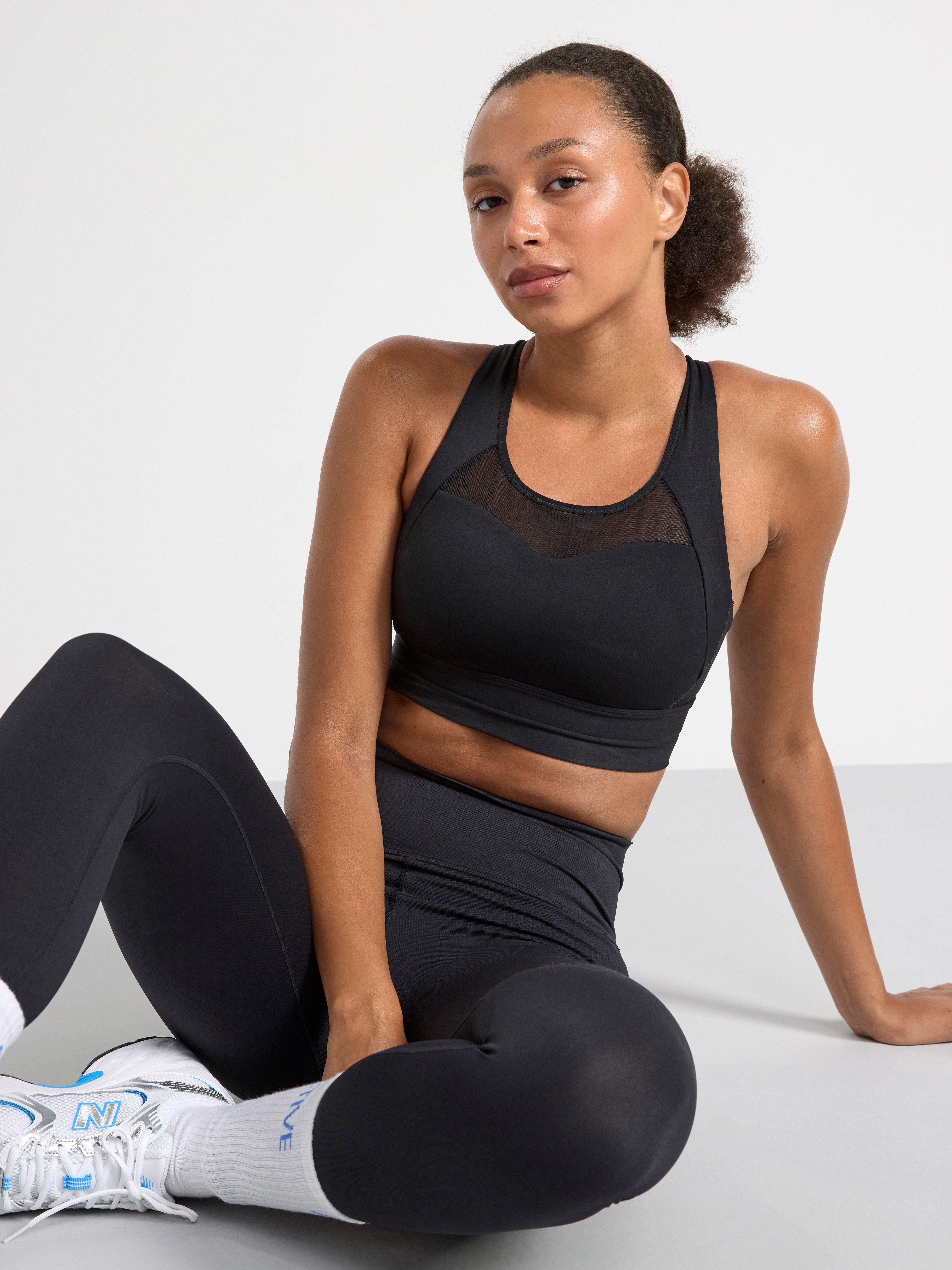 A woman in a black sports bra.