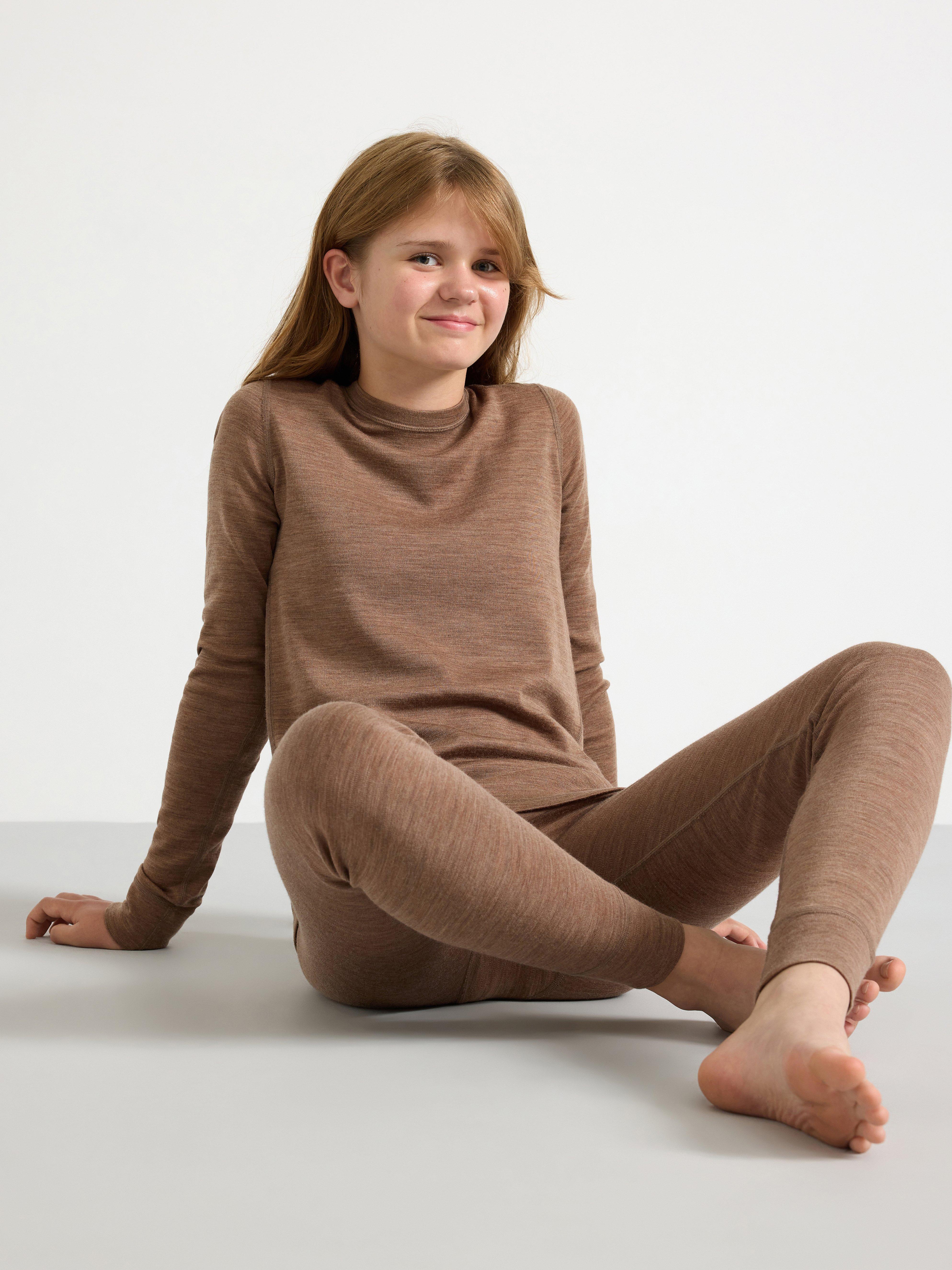A girl wearing a brown merino wool undergarment