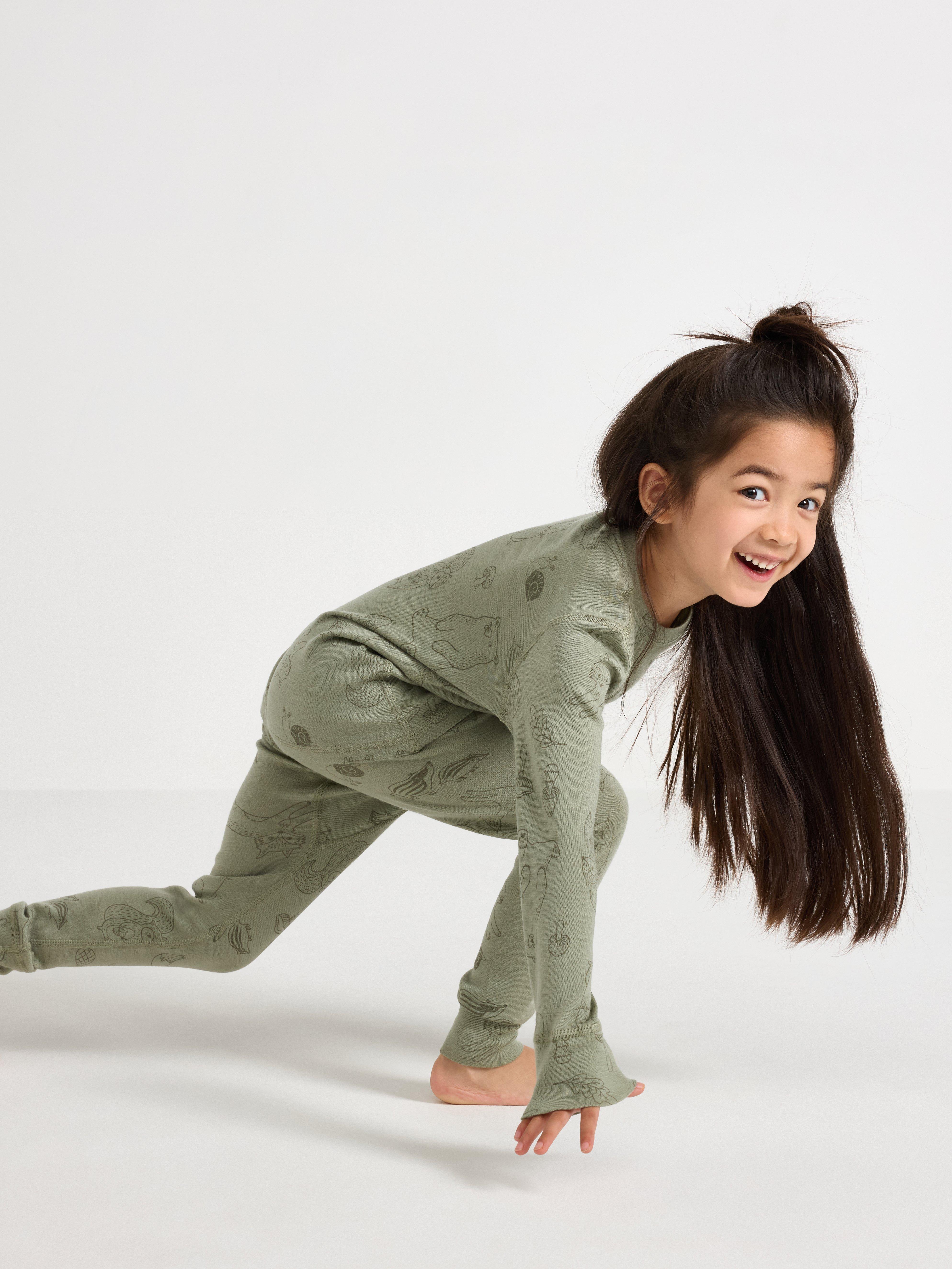 A girl wearing a warm base layer with animal patterns.