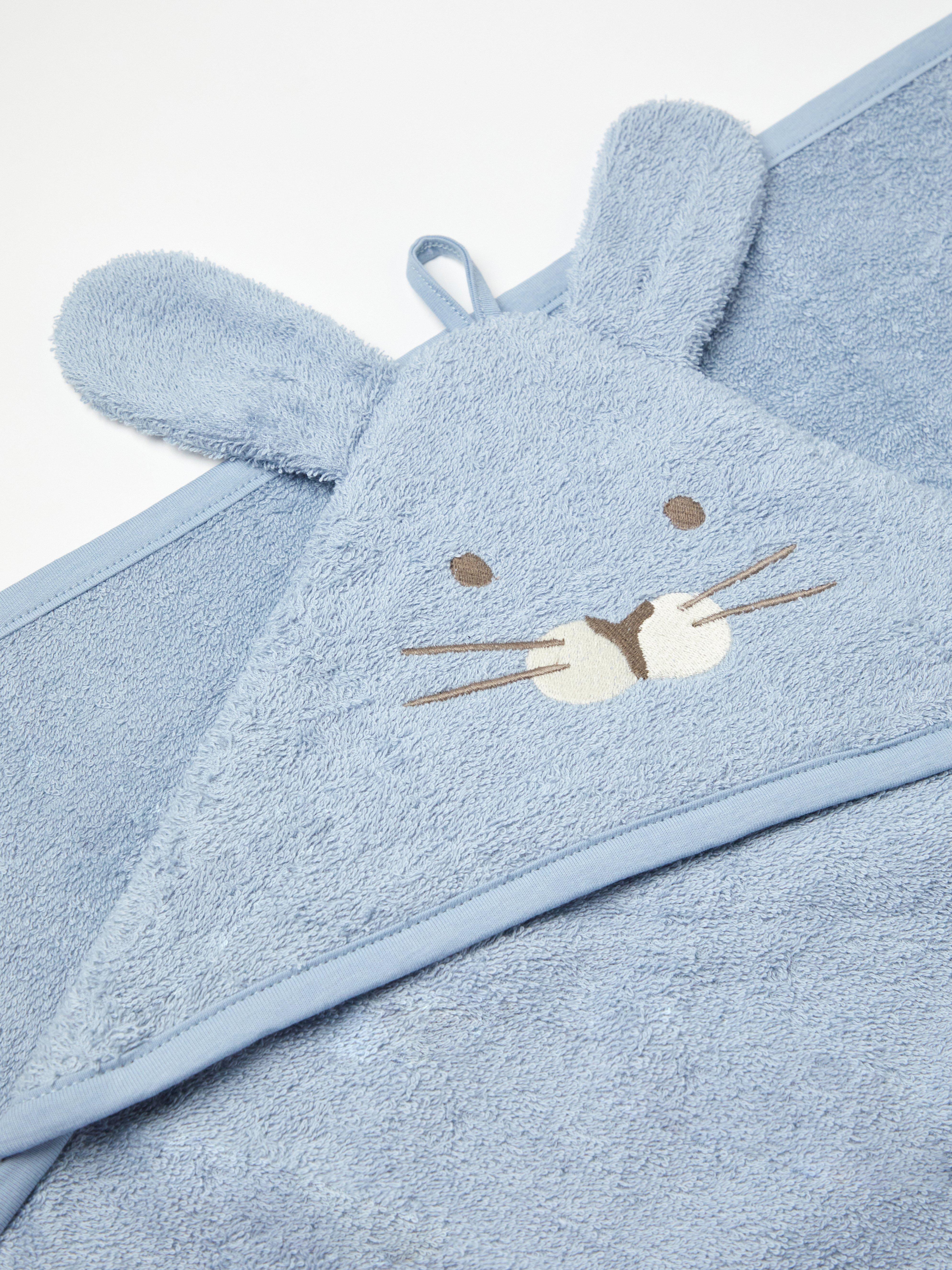 A blue blanket with a rabbit face and ears.