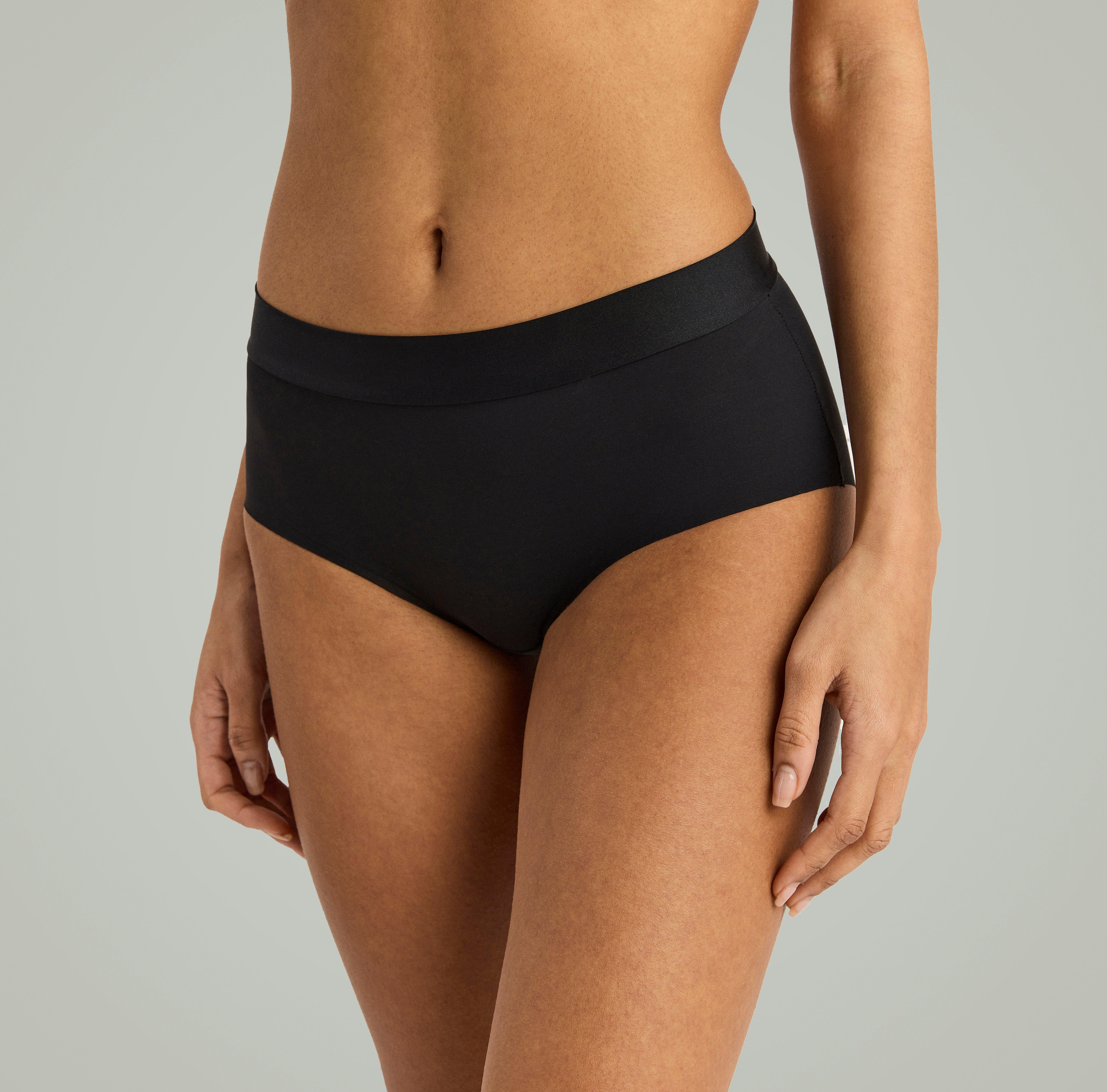 A woman wearing black knickers from Lindex.