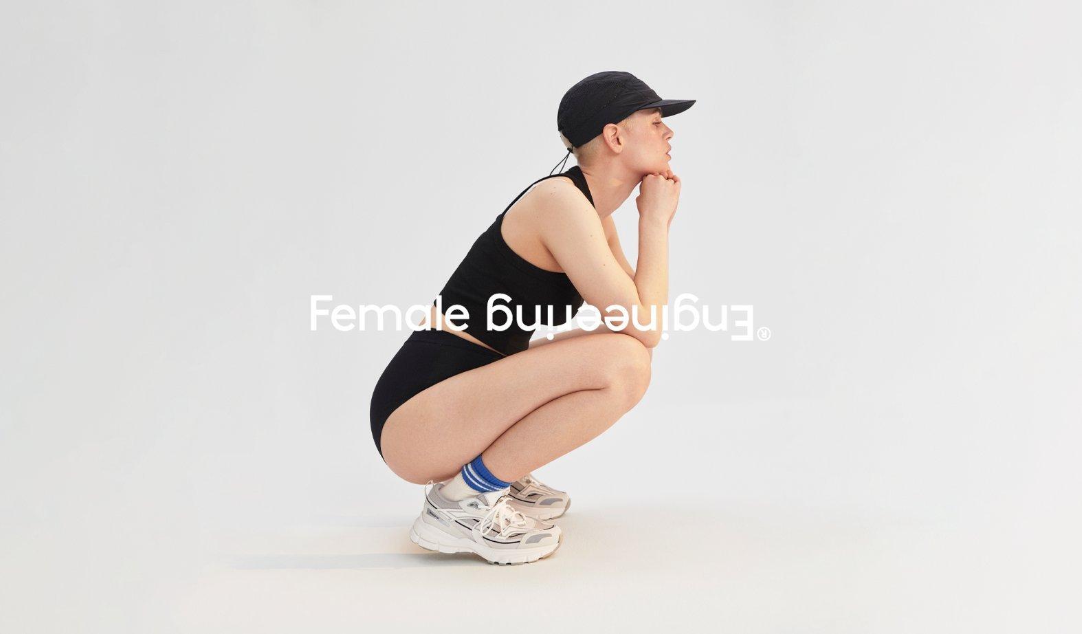 A squatting woman in period panties with the Female Engineering logo.