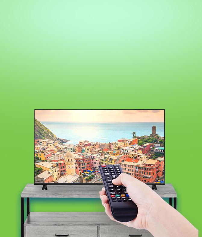 TV on tv stand and hand with remote.