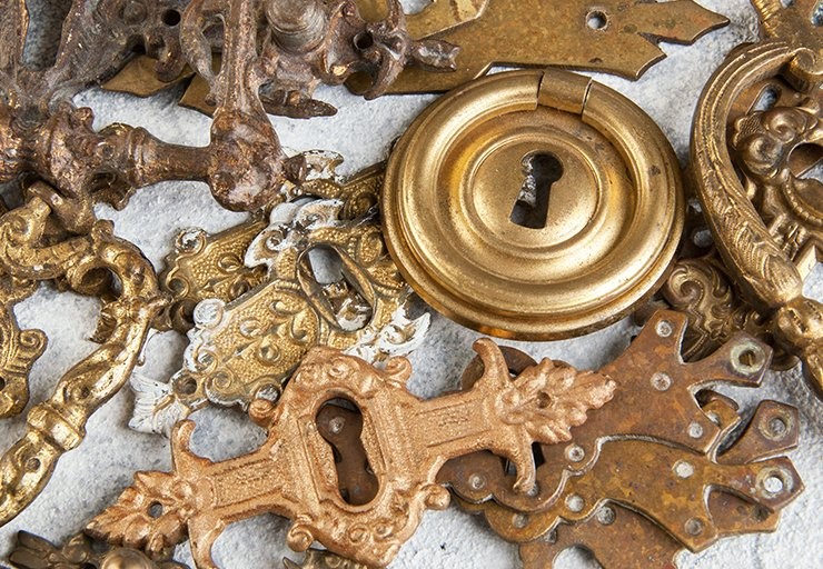 a metal knob and metal accessories laying on a table