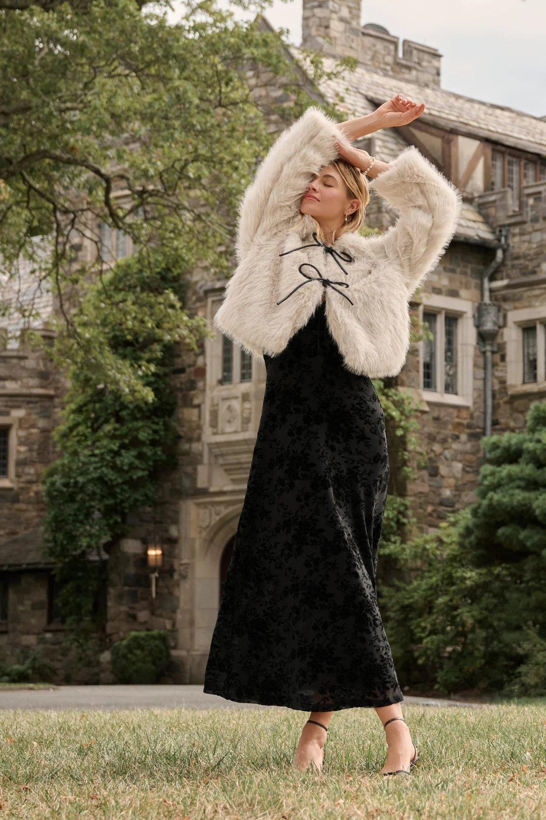 cream fur jacket with black bows