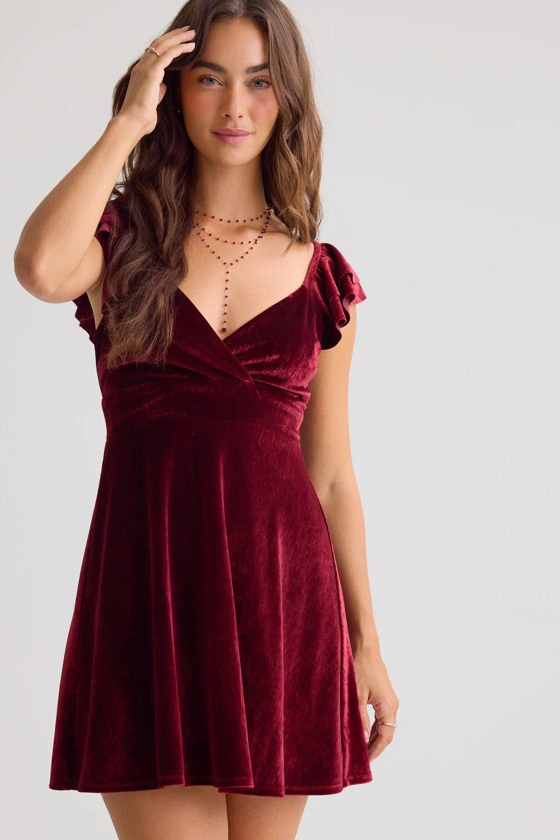 red velvet mini fit and flare dress with flutter sleeves and back tie