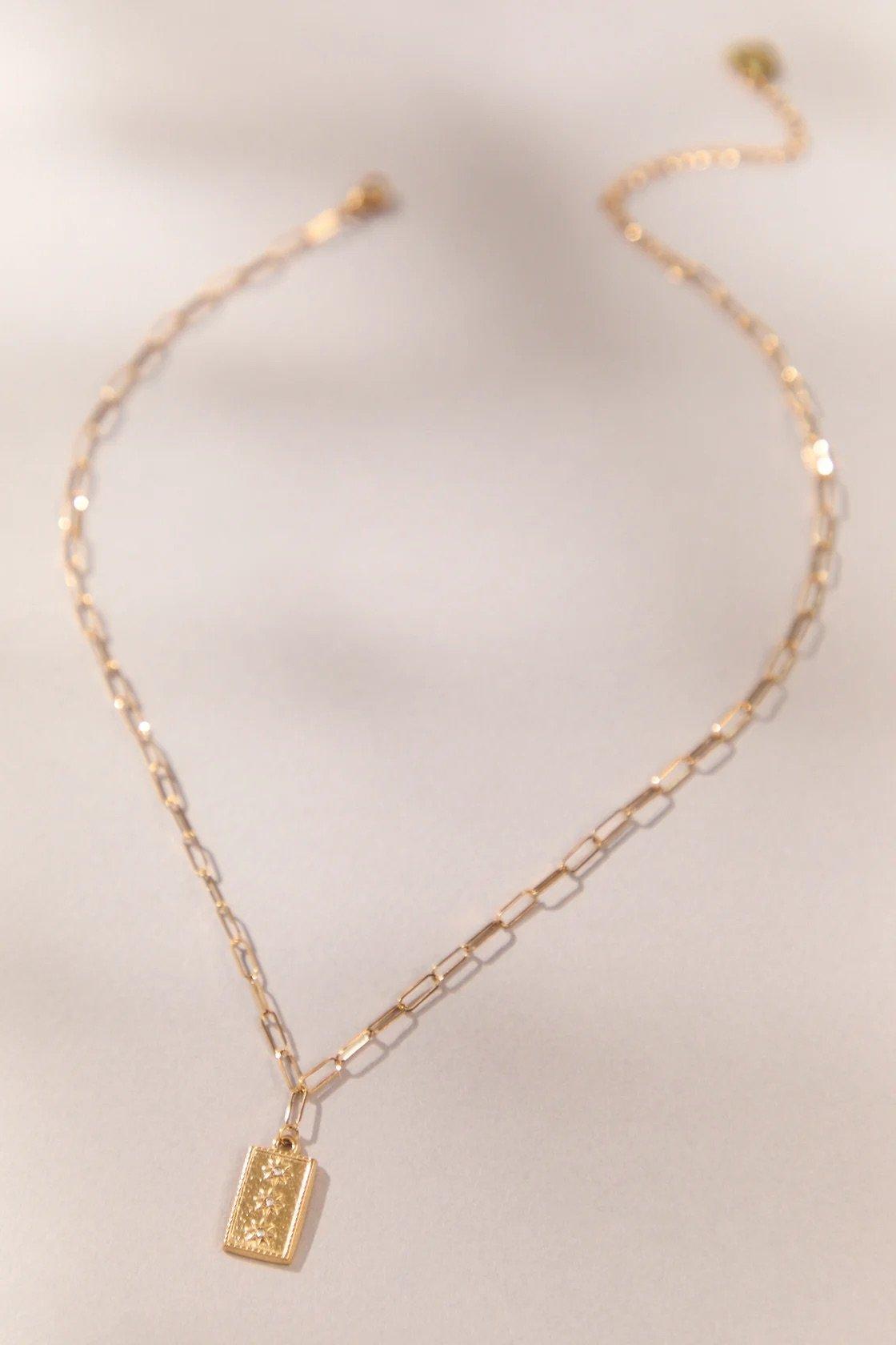 Gold chain necklace with rectangular starbursts pendant