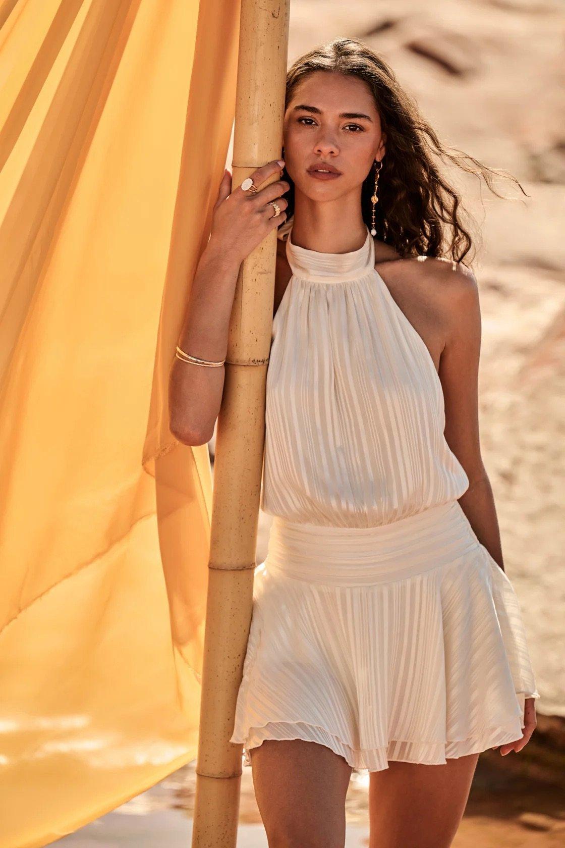 white high necked halter mini dress with a vertical stripe pattern