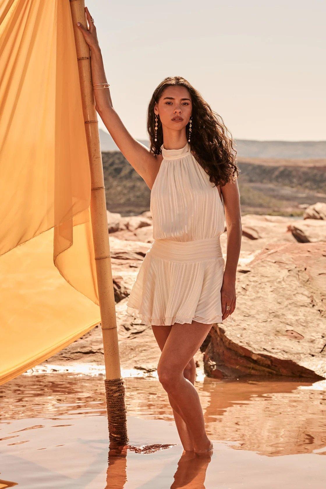 ivory halter drop waist mini dress with subtle vertical striping